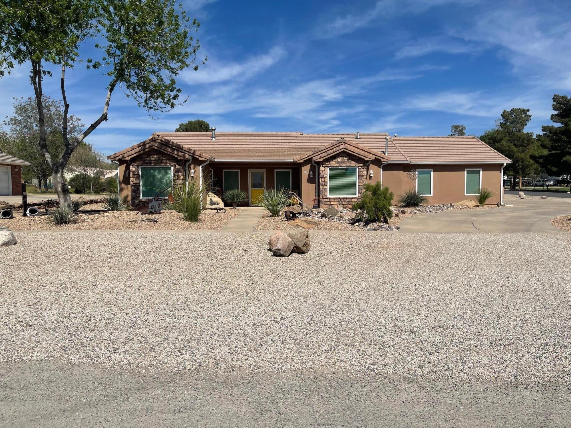 NEW ON THE MARKET.  This unique property offers unmatched desert landscaping and a pristine MUST SEE HOME.  The care and presentation of both inside and out at this level is rarely seen.  The home features 3 bedroom, 2 1/2 baths, granite counters, new windows and 2 gas fireplaces.  Fully fenced yard, irrigation system, RV garage with RV dump and plug in.  Covered porch with fans and shaders.  This rare home is IDEAL FOR ANIMALS.  You'll not find a better value.
