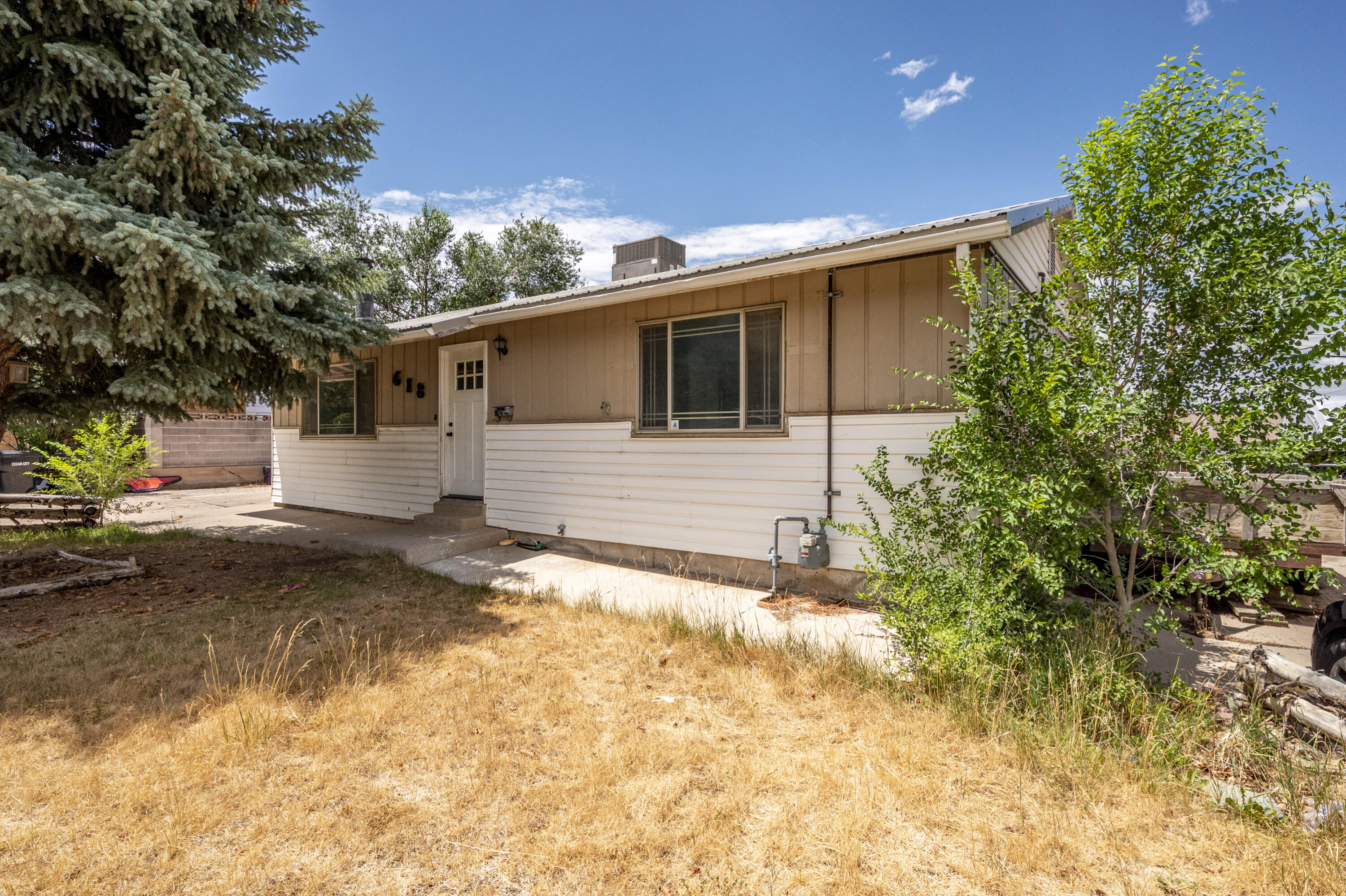 Conveniently located in the heart of Cedar City, this 4-bedroom, 2-bath home offers 2,146 square feet of living space on a fully fenced 0.18-acre lot. Built in 1968, the home features a detached two-car garage, a walk-out basement with direct access to the backyard, and a cozy wood-burning stove downstairs. With plenty of space and a functional layout, this property is ready for someone to bring it back to life. This home does need some work, but with a little TLC and vision, it has tons of potential. Whether you're looking for a project or a home you can update to fit your style, this property offers a great opportunity. Please note: This home is priced just above the seller's current mortgage payoff. The seller is simply trying to break even and does not have funds to bring to closing. The list price reflects that, making this a great opportunity for someone ready to put in a little work and make it their own.