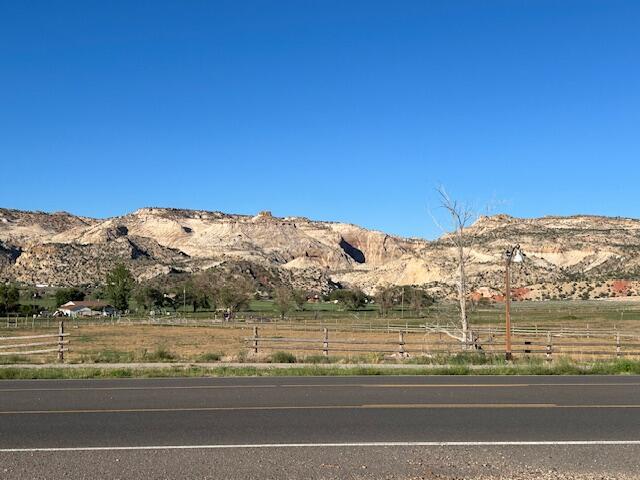 GREAT LOCATION! Large Commercial Parcel with Incredible Views of the Escalante Canyons.  Over 3+ Acres of flat & usable land on the East end of Main St. (Scenic Byway 12), situated in Escalante between Bryce Canyon and Capitol Reef.  Perfect for just about any type of Hospitality, Retail, Restaurant, Recreation rentals, etc. (with approval of Escalante City)  Located near the Clinic, Schools and New Businesses.   Utilities nearby with lots of Frontage.  Buyer to work with UDOT for approval access. Within minutes of the Escalante River Trail Head and Hole in the Rock Road.  Recreation of every kind is at your fingertips! Access to canyons, mountains and everything in between. Don't miss out on this rare Commercial Property in a growing, popular resort town.