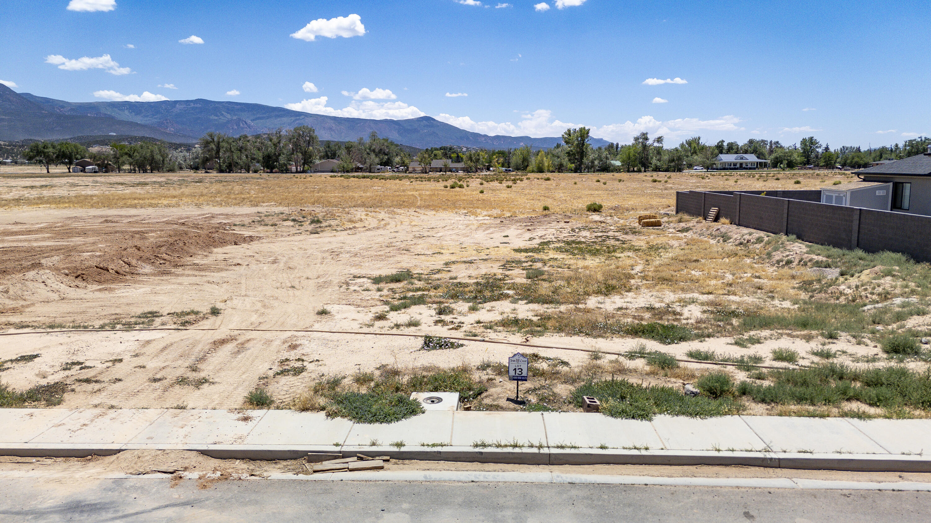 A rare opportunity awaits in Cedar City's Iron Crest Subdivision! Originally sold out, this spacious .33 acre lot in Phase 1 is now available. The flat landscape provides the perfect blank canvas to build your dream home among beautiful custom homes in one of the area's newest neighborhoods. Sidewalk lined streets create a welcoming setting for evening strolls. All utilities, including sewer, water, electricity, and natural gas, are already stubbed to the lot. A block wall along the west property line is already in place, adding value and saving you money. Bring your own builder and make your vision a reality!