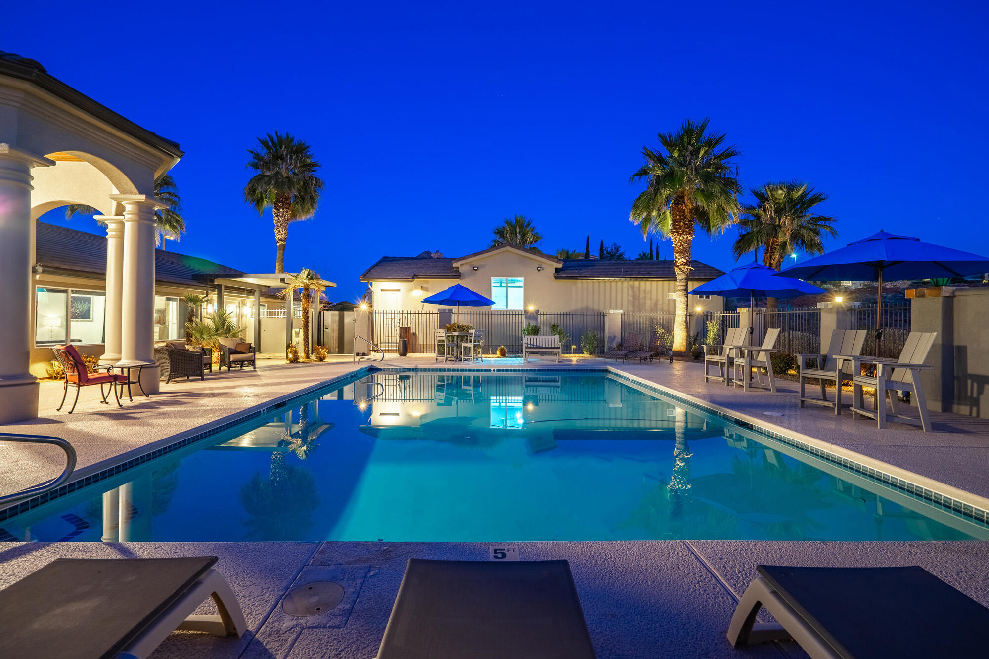 This home sits on over an acre of beautifully positioned land with xeriscape landscaping.  This exceptional property offers space, privacy, and resort-style amenities, with mature palm trees. Enjoy stunning views of Pine Mt. out the front and sparkling city lights out the back. All from the comfort of your own home. For the active life style, this property features two quality built pickleball courts designed for serious play or casual play with family and friends. Just steps away, is an extra large pool that you can swim, or relax in to unwind, complete with its equipment housed in a dedicated enclosed room for convenience and protection. A well appointed pool bath with sink, shower, and toilet , just steps away from the spa.  1/2 bath on side of garage, specifically for the pickleball courts. Car enthusiasts and hobbyists will appreciate the 2 car garage and smaller RV garage.  Plenty of room for recreational toys or storage. Epoxy floors and special lights and painted perfectly for a man or woman cave. A MUST SEE!  Attached to the garage is a charming casita-perfect for guests, extended family or a private office. Inside the home is custom black walnut cabinets which offers abundant storage through out. Many custom lights, tiles, and counter tops. This property truly delivers a rare opportunity to own a private estate designed for living well. (Owner is a licensed real estate agent)
