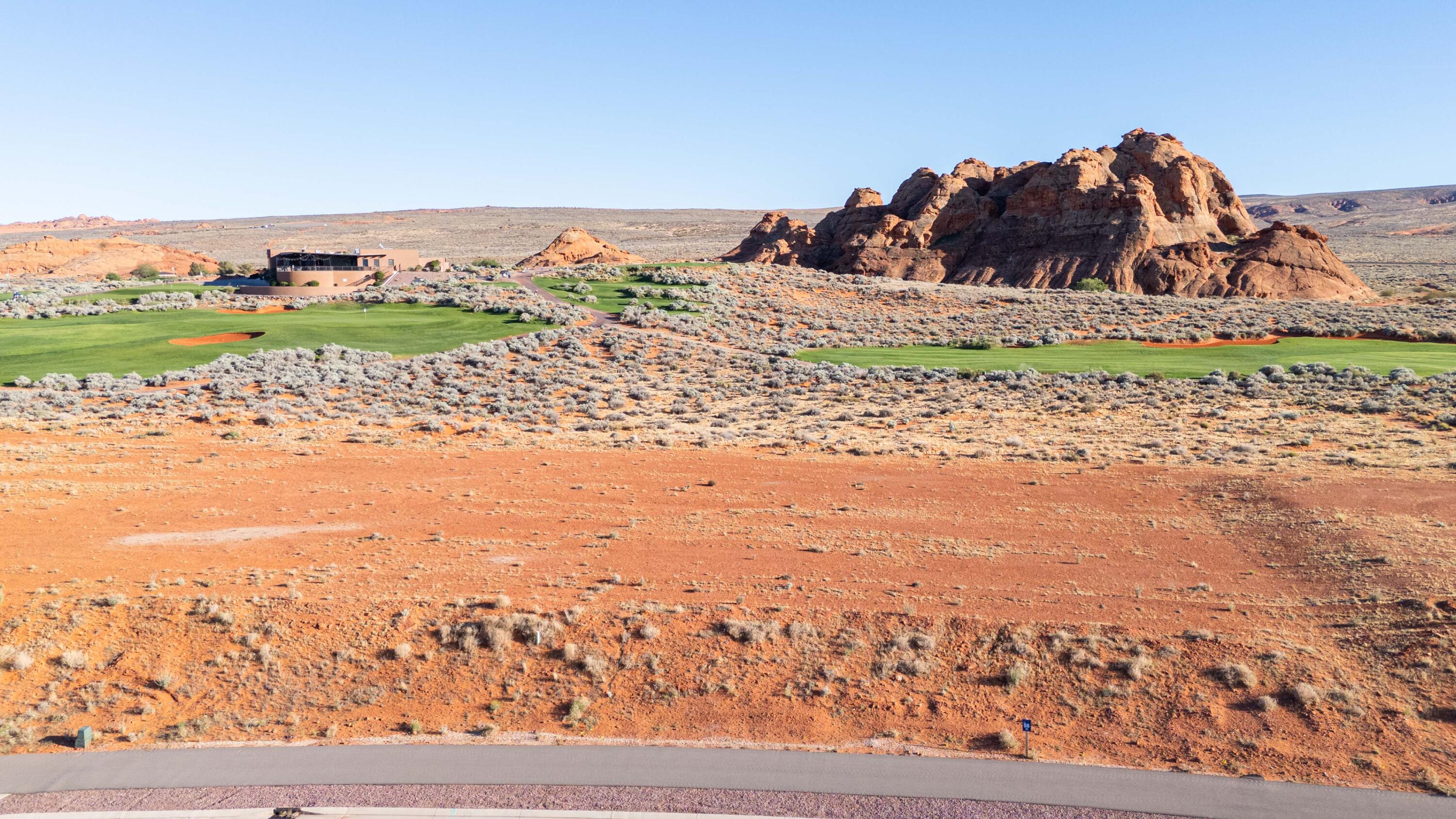 Exclusive golf course living at its finest. Lot 56 sits directly on the tee box of Hole 10, the opening of Sand Hollow's celebrated back nine -- one of Golfweek's Top 100 Resort Courses in the United States. At slightly over three-quarters of an acre with a flat, pad-ready homesite, this is a rare opportunity to build a luxury custom residence at Southern Utah's most sought-after address. The Estates has hosted multiple Parade of Homes events, with showcase residences selling to buyers who recognize this as the region's premier community.

From your backyard, watch golfers tee off while taking in direct views of the resort clubhouse, the Hole 9 green, and a dramatic sandstone formation at the lot's edge that no builder could replicate. Facing west, the property captures open desert sunsets every evening. Directly across the street, Sand Hollow State Park offers reservoir boating and a sandy beach within minutes. Zion National Park, Brian Head Ski Resort, and Lake Powell are all within easy reach for year-round adventure.

The region is thriving -- a new hospital, Hurricane schools, and two destination resort developments with water parks are all underway nearby. Ownership includes the exclusive Sand Hollow Clubhouse, seasonal pools, fitness center, The Grille, and HOA-covered landscaping and hourly security patrol. Homeowner perks include 40% off Championship Course green fees, discounts on The Links, the Pro Shop, The Grille, and 10% off Mad Moose UTV and watercraft rentals on property.

The lot accommodates an estate-style home, resort pool, casita, and oversized garages. Premier approved builders available, or bring your own. 15 minutes to St. George Airport. 90 minutes to Las Vegas.