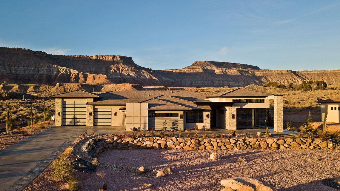 Rare opportunity to own a luxury home with short-term rental potential just minutes from Zion National Park. Under the Town of Virgin's Residential Hosting Ordinance, this property may be operated as a vacation rental provided a full-time resident occupies a portion of the home. The resident does not have to be the owner, creating a unique opportunity to generate nightly rental income while maintaining long-term occupancy. For example, the detached casita behind the RV garage could be leased to a full-time resident while the main home operates as a vacation rental, or vice versa. Buyer is responsible for verifying all zoning, ordinances, permitting, and short-term rental requirements.

Purposefully designed for hosting, this exceptional custom home features five luxurious bedroom suites, each with its own private exterior entrance and individual mini-split climate control, providing comfort and privacy for guests. Perched above a pristine stretch of the Virgin River, the property captures spectacular views of Gooseberry Mesa and the adjoining 420-acre conservation preserve, offering a peaceful setting just outside Zion National Park.

Designed to embrace Southern Utah living, the home features more than 800 square feet of covered patio, an elevated observation deck pre-plumbed for a propane fireplace with built-in speakers, and seamless indoor-outdoor spaces perfect for entertaining. Premium features include whole-home Sonos audio throughout the house, garage, and outdoor living areas, wiring for powered window coverings, a reinforced concrete vault room with 8-inch walls and ceiling, and an oversized 50-foot-deep RV garage with a 14' x 14' door.

Whether you're searching for a luxury primary residence, an incredible vacation retreat, or a property with a rare blend of personal enjoyment and income potential, this one-of-a-kind home delivers exceptional craftsmanship, remarkable flexibility, and an unbeatable location at the gateway to Zion National Park.