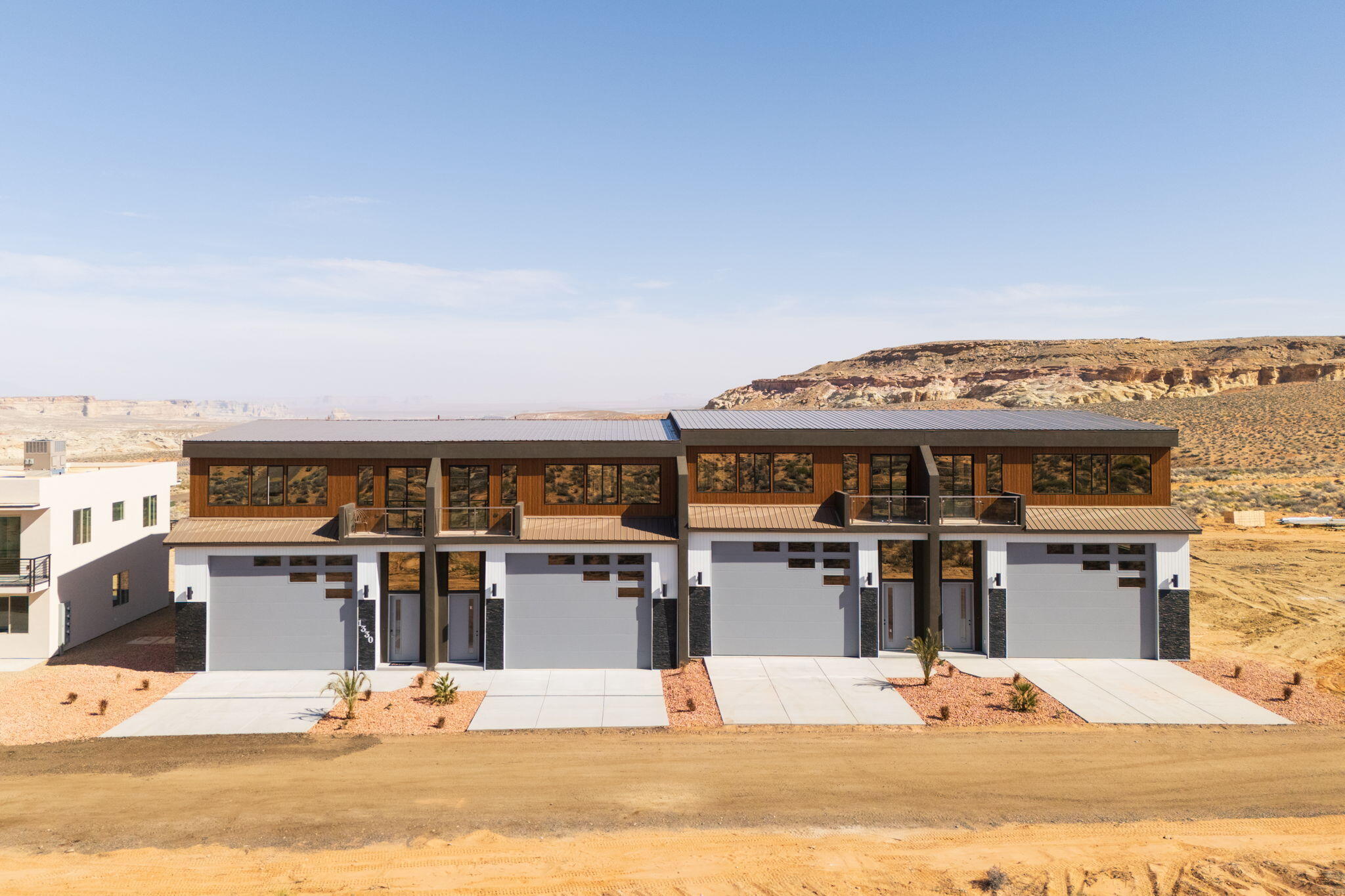 YOUR LAKE POWELL ADVENTURE HEADQUARTERS!
Units are offered as a ''gray shell'' — a blank canvas ready to finish to your taste. Each features 1,637 sq. ft. of garage/storage (14x16 door, 55 ft deep) — perfect for boats, RVs, and toys — plus 1,358 sq. ft. of upper-level living space with high ceilings and a covered patio. That's nearly 3,000 sq. ft. total for your Lake Powell retreat or investment property. Nightly rental approved — imagine storing your boat and having your upper level pay for it!