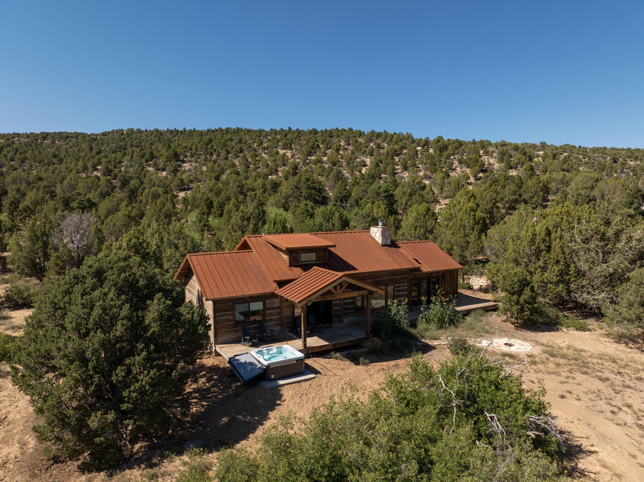 Peach's Cabin Lodge 223 - A Luxury Rustic Escape situated on a sprawling, wildlife-rich property just outside Zion's East entrance.
Set on nearly two private acres at 6,000 ft elevation, Lodge 223 blends upscale comfort with timeless mountain charm. Accommodating up to 10 guests, the cabin offers five beds across two thoughtfully designed levels, a vaulted loft, and a stone fireplace anchoring the inviting living space. Modern amenities pair seamlessly with warm wood and natural stone finishes. Outside, a spacious deck with plush seating, a hot tub, and a fire pit creates the ultimate setting for starlit evenings. Just minutes from Zion National Park, this refined rustic retreat offers serenity, seclusion, and an unforgettable connection to nature. Active STR Peaches at Zion Mountain Ranch is situated on approximately 300 acres of rugged, serene wilderness, this guest ranch sits ideally near Zion National Park's eastern entrance. A portion of the property includes a 600-acre buffalo preserve, allowing visitors to view roaming bison right from their cabin doorstep.
Guests enjoy an authentic western experience in private cabins and lodges crafted with rustic, reclaimed finishes and modern comforts. This isn't just a place to sleepit's an experience. Enjoy guided hikes, canyoneering, horseback riding, jeep tours, and nightly campfires under some of the clearest night skies in Southern Utahideal for stargazing. Plus, the property supports rich wildlife encountersvisitors often spot deer, rabbits, and of course, bison.

The ranch is a standout home-base for exploring not just Zion, but also Bryce Canyon, the North Rim of the Grand Canyon, Grand Staircase Escalante, Cedar Breaks, and Lake Powellall within comfortable driving distance.