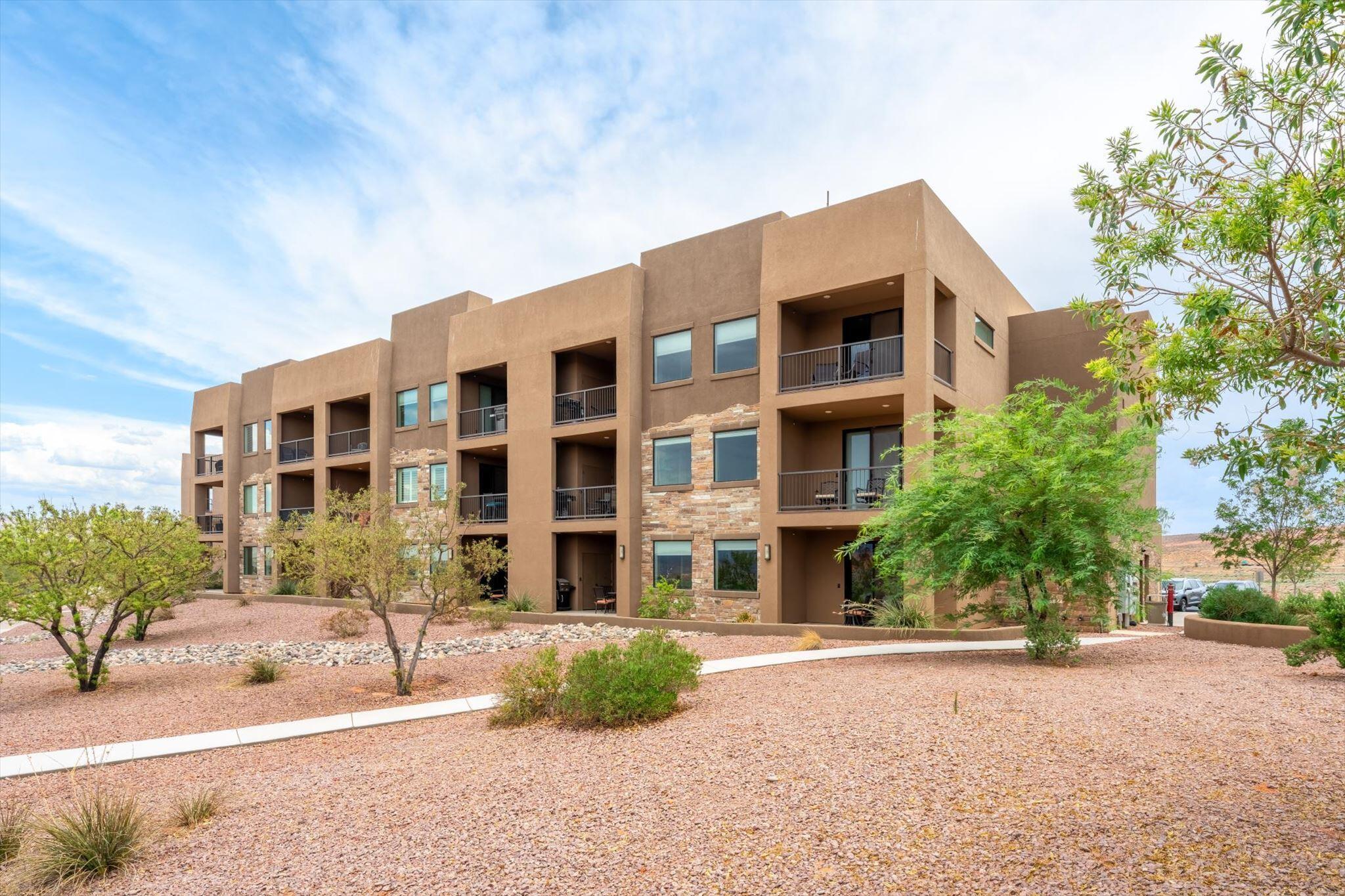 Nightly rental approved and just minutes from Sand Hollow Reservoir, this beautifully appointed 2 bedroom, 2 bathroom condo offers the perfect blend of investment potential, vacation living, and Southern Utah adventure. Whether you're expanding your short-term rental portfolio, searching for a second home, or looking for a lock-and-leave getaway, this turnkey property is ready to enjoy.

Inside, the open-concept floor plan is filled with natural light and features granite countertops, rich wood cabinetry, stainless steel appliances, abundant storage, and a spacious island with bar seating. The kitchen flows seamlessly into the dining and living areas, creating an inviting space for entertaining and relaxing.

The split-bedroom layout provides privacy for owners and guests. The spacious primary suite offers direct access to the oversized covered balcony and an ensuite with dual vanities, granite countertops, a soaking tub, separate walk-in tiled shower, and generous storage. The second bedroom comfortably accommodates two queen beds, maximizing rental flexibility. A second full bathroom and dedicated laundry room add convenience.

Step outside to the expansive covered balcony overlooking the resort-style pool while enjoying sweeping views of the surrounding desert landscape, red rock mesas, and distant mountains.

Residents and guests enjoy a sparkling pool, hot tub, elevator access, beautifully maintained grounds, and ample parking. Ideally located just minutes from Sand Hollow State Park, championship golf, boating, wake surfing, paddleboarding, fishing, hiking, biking, world-class ATV trails, and Zion National Park, this condo places endless recreation at your doorstep.

With desirable nightly rental zoning, outstanding amenities, breathtaking views, and an unbeatable location, this is an exceptional opportunity to own an income-producing vacation property and your own private desert retreat.