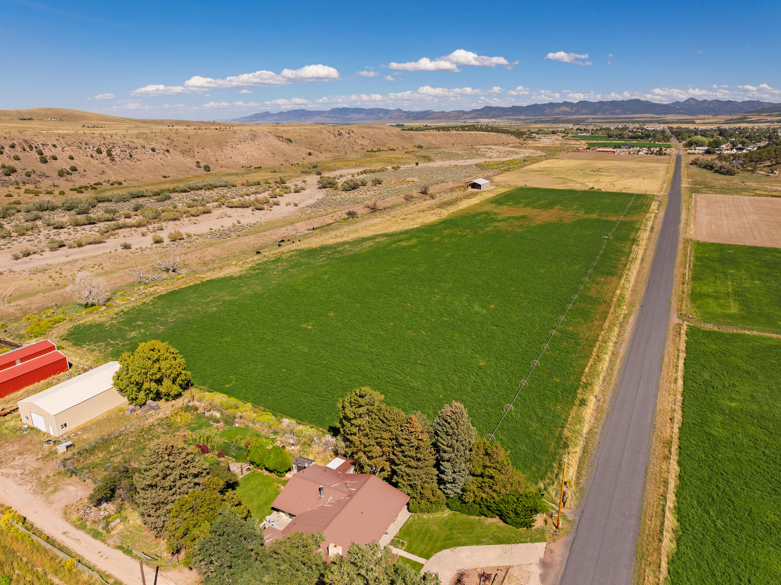 181.77 acres for sale in city limits in Enterprise, UT. Currently being farmed. Includes 230 shares of Enterprise Reservoir and Canal Company. Water shares are being used to irrigate Southwest 15 acres of land currently. Southeast 30 acres are currently set up for dry farming/grazing. Power is located on the property. Hay barn (85x55) and wheel lines are included in the sale. Currently being assessed in Greenbelt for taxes. Build a residential home and keep farming the land. 

Other possibilities include developing a residential subdivision with 45 acres on the South flat land. Developers would have to bring city utilities from the nearest connection to the property. So many different ideas and opportunities with this land. Come and see it.