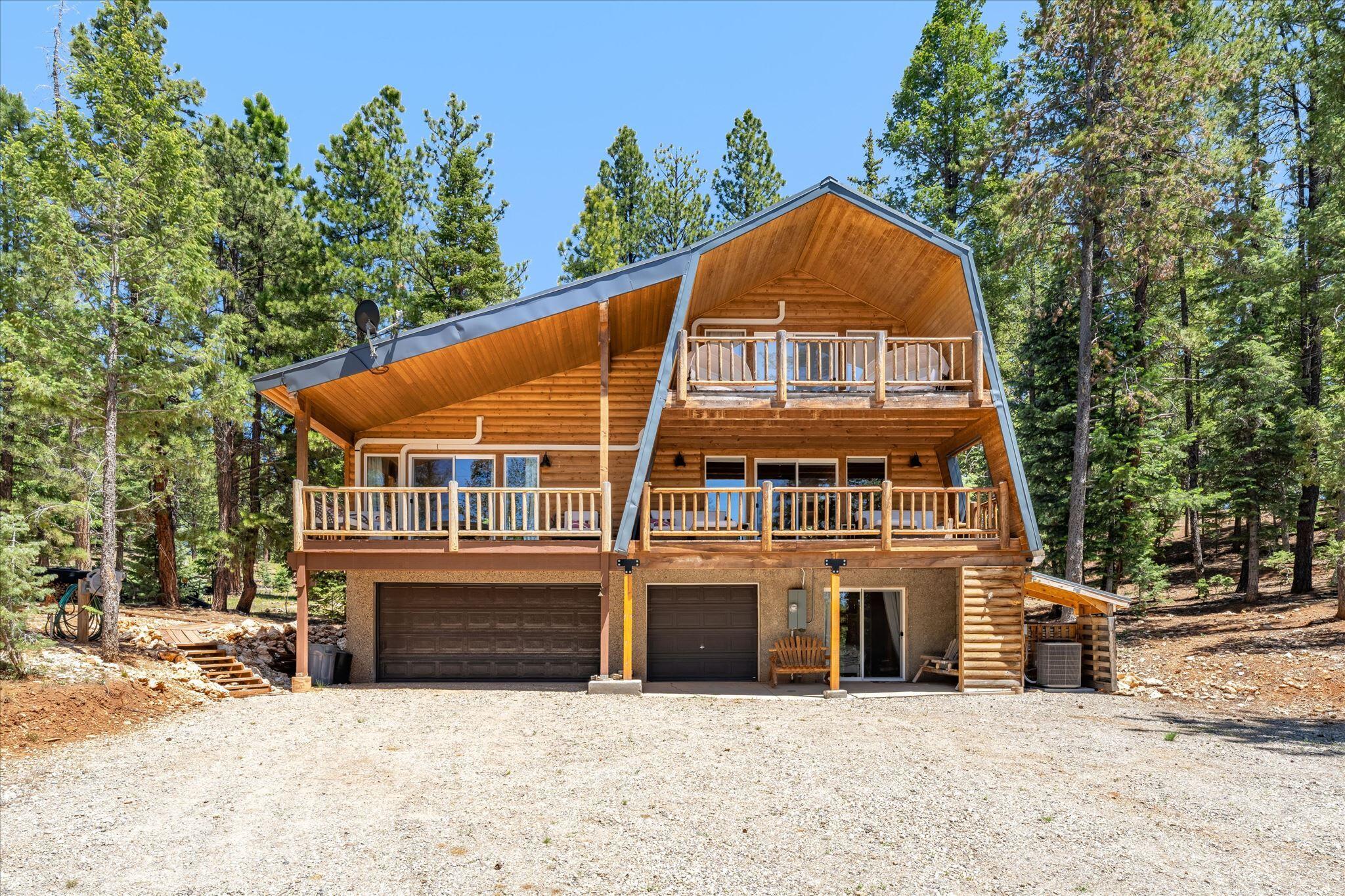 Tucked away at the end of a quiet cul-de-sac and backing directly to National Forest, this mountain retreat offers the privacy, space, and adventure you've been searching for. Situated on a  wooded 0.95-acre lot, the property provides room to expand, easy ATV access to miles of forest trails, and front-row seats to the area's abundant wildlife from both the front and rear decks. Designed with flexibility in mind, the cabin features two spacious primary suites. The main-level suite offers a large picture window, walk-in closet, kitchenette, private entrance, and its own secluded feel, making it ideal for guests, multi-generational living, or a private retreat. The second primary suite is located upstairs, while an additional bedroom and ¾ bath on the lower level provide plenty of room for family and visitors. The warm tongue-and-groove interior creates an authentic mountain cabin atmosphere, complemented by a wood stove, furnace, and two electric fireplaces for year-round comfort. The main level also features a welcoming living room, kitchen, dining area, mud room, and convenient half bath. Outdoor enthusiasts will appreciate the attached two-car garage, dedicated ATV storage, and direct access to the surrounding forest. Modern conveniences include power, water, septic, cell service, landline, satellite capability, exterior lighting, and security cameras. The community offers  amenities, including a stocked fishing pond, large pavilion with BBQ areas and picnic tables, horseshoe pits, playground, restrooms, private airstrip, fenced meadow and stream for horses, fire hydrants, year-round road maintenance with winter snow removal and summer dust control. Whether you're looking for a full-time mountain residence, a family getaway, or a recreational basecamp, this property offers a rare opportunity to enjoy mountain living with comfort, privacy, endless outdoor recreation right outside your door. Furniture and personal property are not included unless otherwise negotated