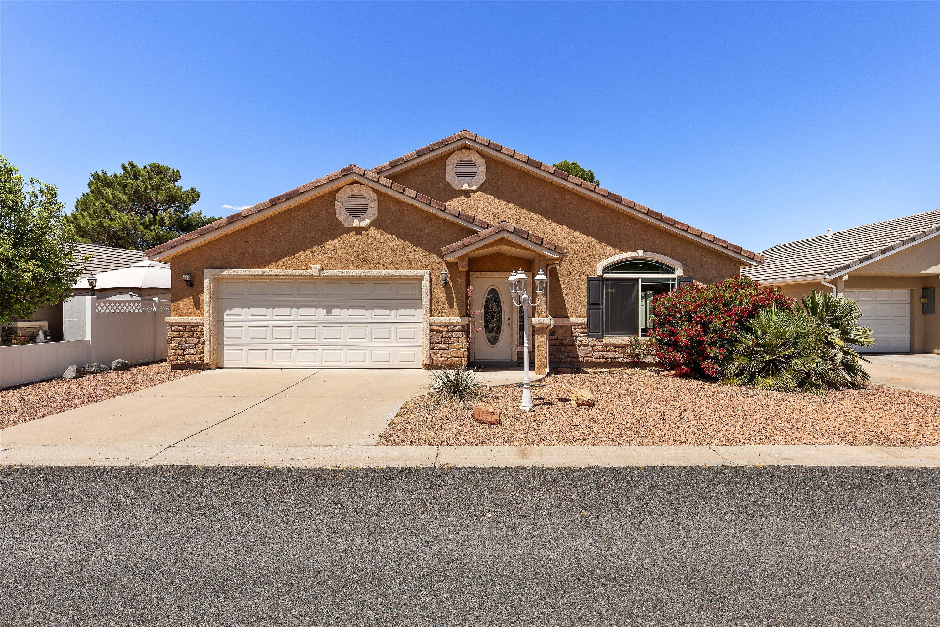 Located in Quail Lake Estates, this 2003 stick-built single-family home offers 1,298 sqft, 3 bed, 2 bath, 2-car garage on a 0.10-acre lot with a private fully fenced backyard perfect for kids & pets. Features include new LVP flooring, new interior paint, Corian countertops, tile roof, stucco/rock exterior, easy-maintenance landscaping, pergola-covered patio, and included fridge plus washer/dryer. HOA is $91/month and includes clubhouse, heated pool, playground, pavilion, sewer, water, garbage, common area maintenance, and private roads. Near Sand Hollow, Quail Creek, Zion National Park, golf, hiking, biking, boating, fishing, shopping, and only 15 minutes to St. George.