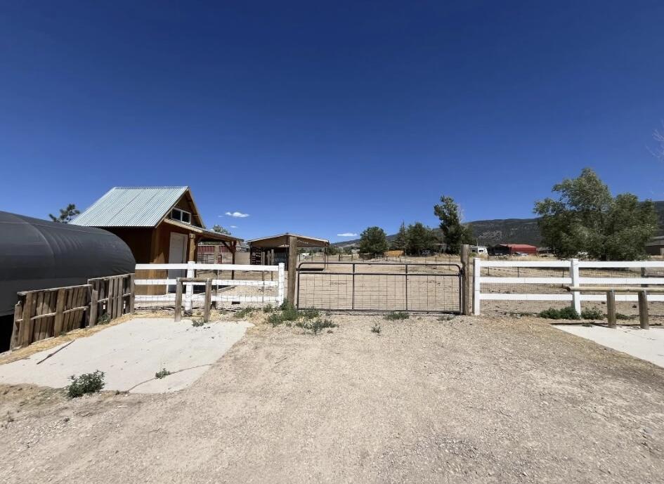 Features convenient access from two separate roads, including one paved entrance and one gravel access point. Improvements on the lot include a covered structure tack shed. No water right attached to this property, price listed to be sold ''as is'' OR if buyer is interested, seller will include a Cherokee Timberwolf trailer and a $10,000 credit to help pay water fees. Price would be $139,000. Buyer to verify utility connection availability and associated fees.