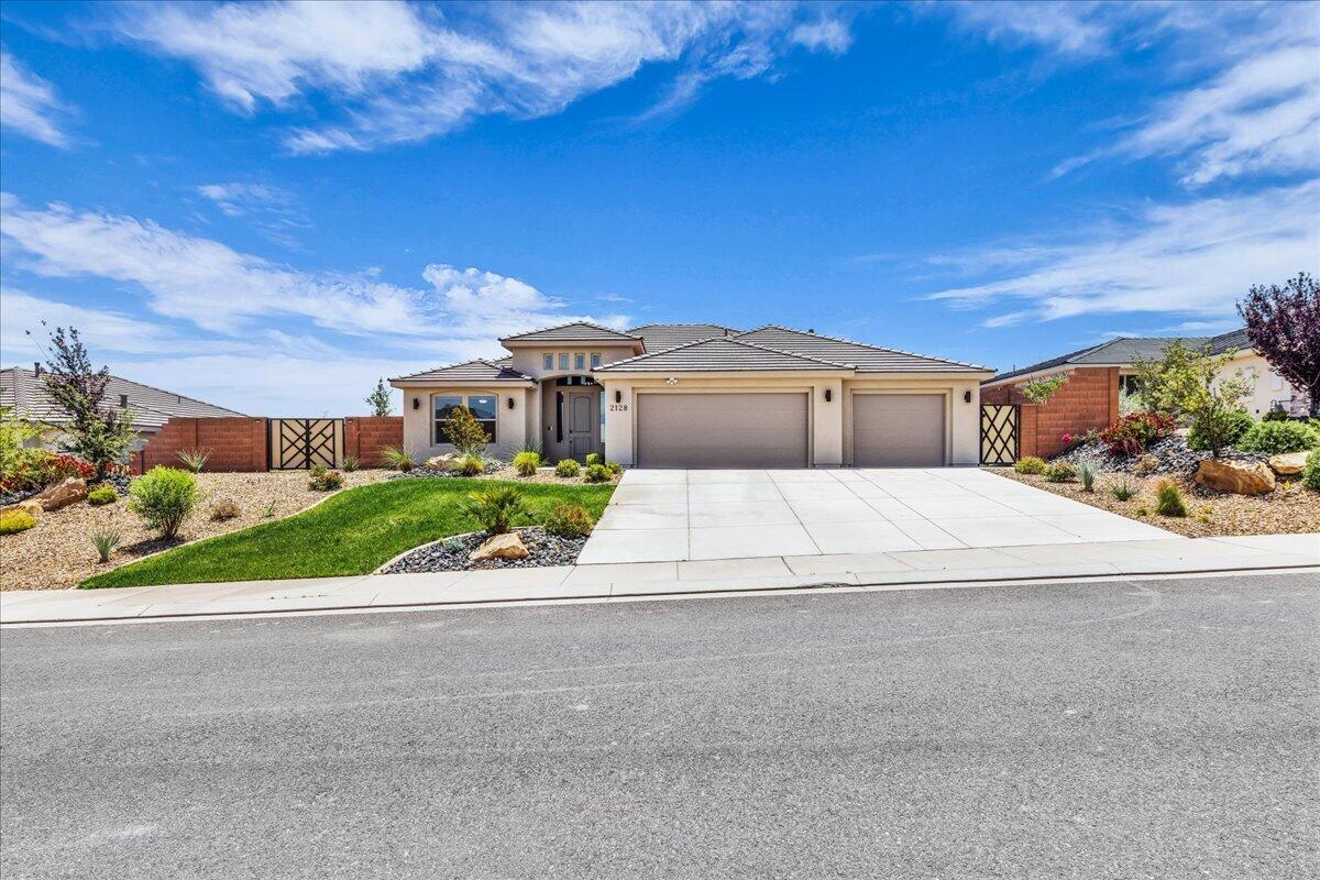 Modern desert living meets comfort and style in this beautifully designed home featuring an open-concept layout, soaring ceilings, and expansive living spaces filled with natural light. The stunning kitchen is the centerpiece of the home with a massive quartz island, sleek dark cabinetry, designer lighting, walk-in pantry, and seamless flow into the spacious great room--perfect for entertaining or everyday living. Additional upgrades include electric blinds in living room and primary bedroom, samsung appliances, upgraded cabinetry throughout, upgraded LVP flooring.  Step outside to a large covered patio and fully fenced backyard with plenty of room to create your dream outdoor retreat while enjoying peaceful desert surroundings and mountain views. Complete with a 3-car garage, beautiful curb appeal, and located in a desirable neighborhood, this home combines modern elegance with functional living