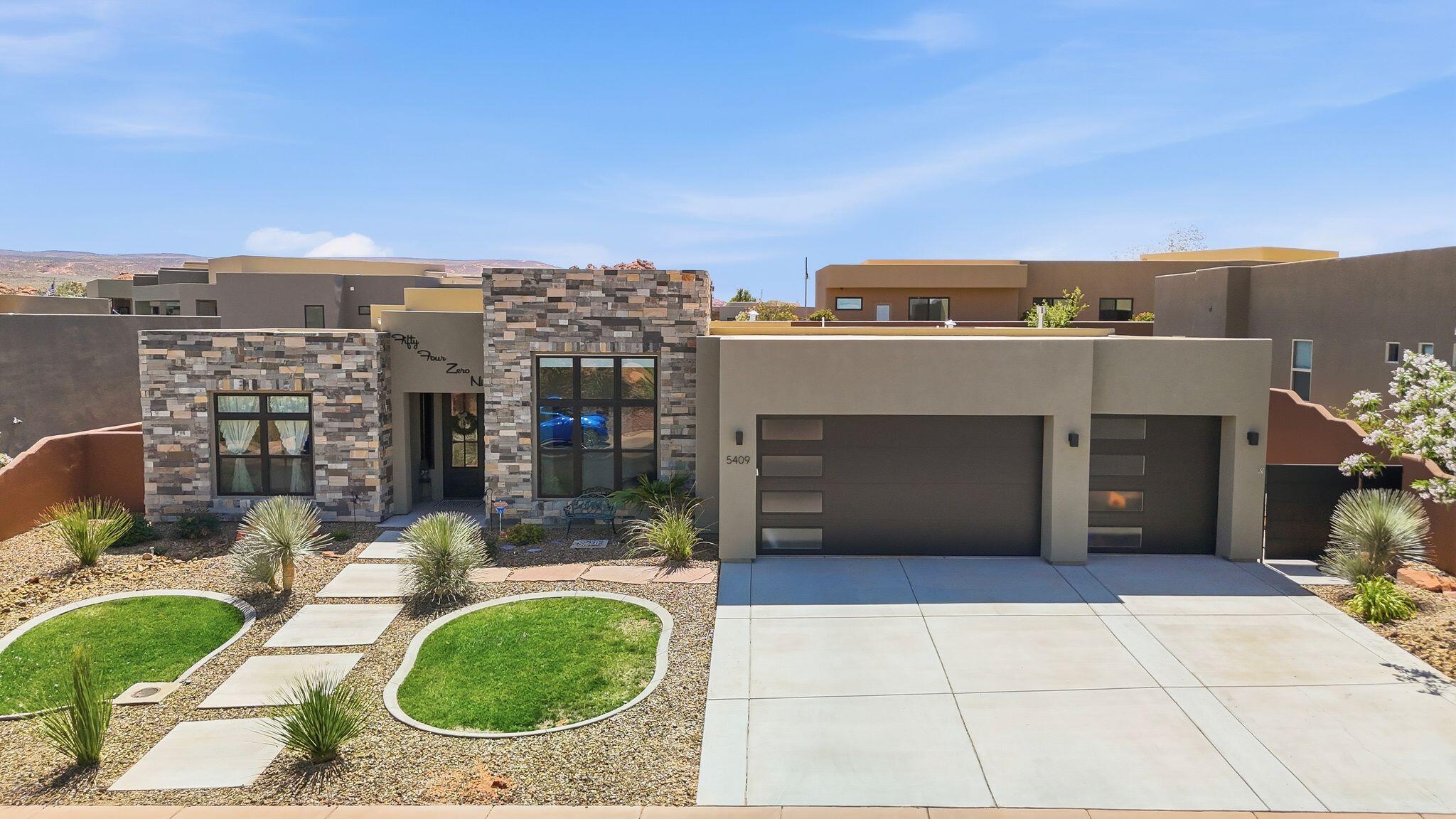 Welcome to elevated desert living in the highly sought-after Dunes at Sand Hollow Resort. This beautifully customized home blends warmth, comfort, and luxury with an inviting open-concept design, thoughtfully upgraded interiors, and expansive windows that flood the space with natural light.

Designed for both relaxation and entertaining, the spacious covered patio creates the perfect setting for indoor-outdoor living, complete with large sliding doors that seamlessly bring the outdoors inside. The oversized yard offers endless possibilities with room for a pool, putting green, or your own private backyard retreat.

The attention to detail continues into the garage with a stunning epoxy-coated floor that adds both durability and a polished finish. But the true showstopper is the incredible rooftop deck featuring breathtaking 360-degree views of the golf course, Zion, and Pine Valley Mountains. Whether you're entertaining guests, enjoying a sunset, or watching fireworks under the stars, this rooftop oasis is an unforgettable bonus space.

Living at Sand Hollow Resort means embracing the ultimate Southern Utah lifestyle. HOA dues include front- and back-yard maintenance, allowing you to toss the lawnmower and spend more time enjoying everything this incredible community has to offer. Residents receive discounts at both the Championship and Links golf courses, along with savings at the clubhouse dining and pro shop.

From peaceful walks to the reservoir and hiking among the red rocks to side-by-side adventures and world-class golfing, outdoor recreation is truly at your doorstep. This is more than a home -- it's a lifestyle.