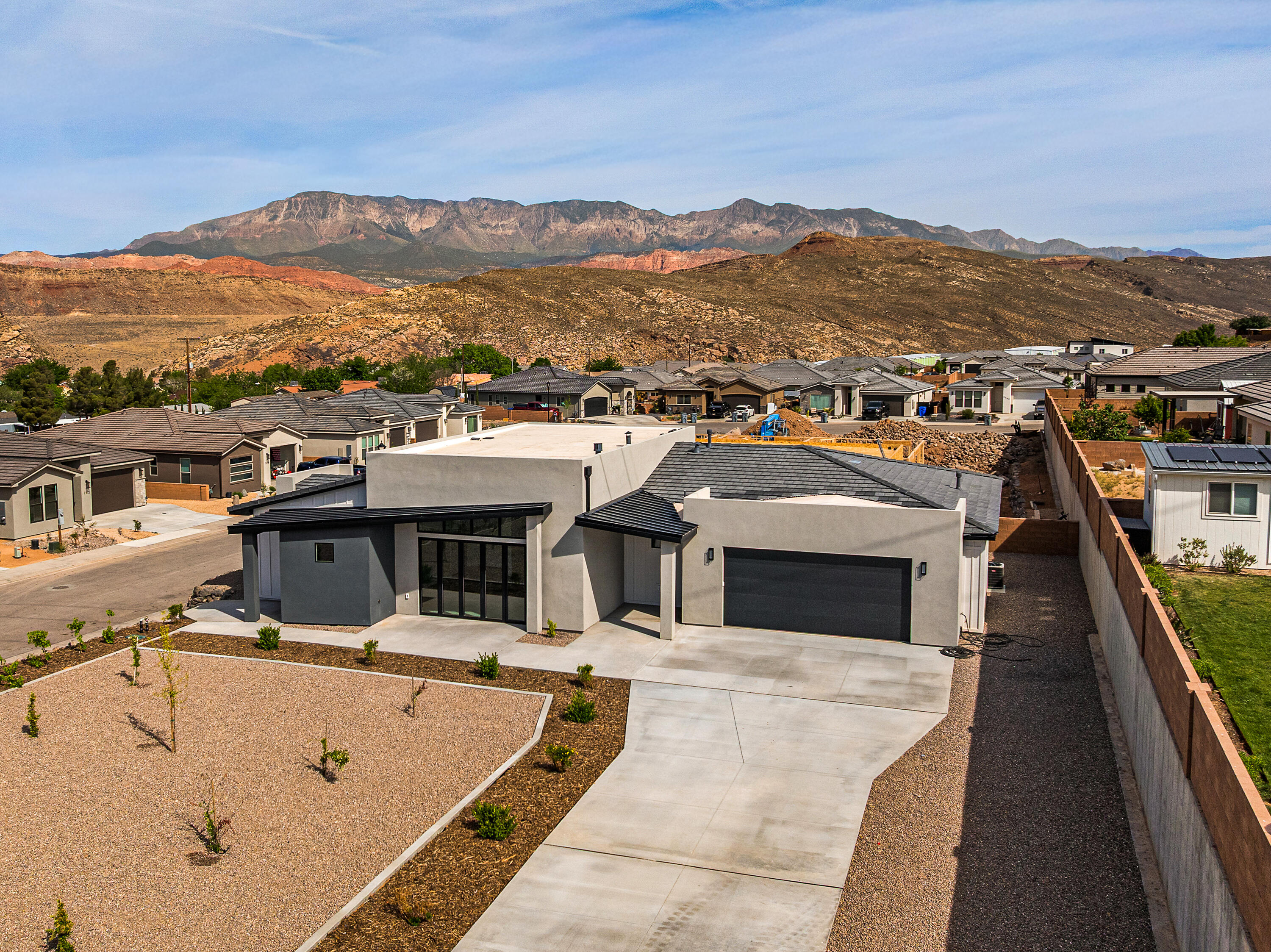 Spectacular elevated views--this is the crown jewel of the Builder's Reserve, the final and most coveted phase of Zions Gate. Perched above the rooftops on a rare, oversized homesite, it feels private, open, and above it all. Inside, soaring space and light define the great room, anchored by a statement fireplace and wrapped in custom cabinetry and large-format tile. Two primary suites offer flexibility for guests or multi-gen living, while a formal dining room sets the stage for unforgettable evenings. The oversized garage? Room for trucks, toys, and everything in between. This is where quality meets presence.