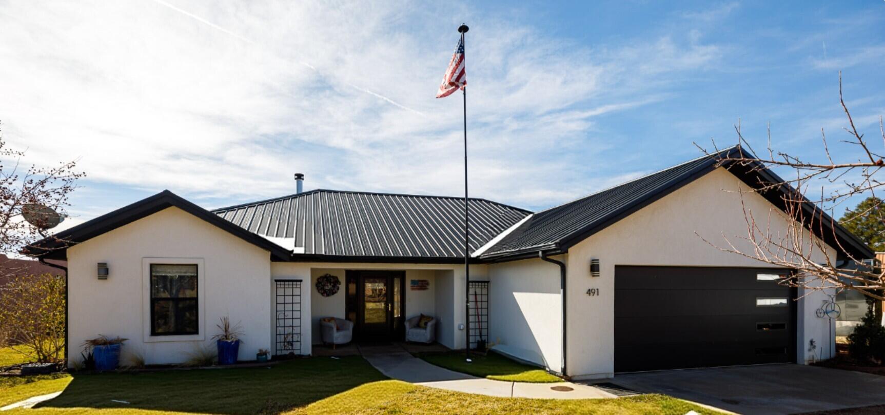 Completely reimagined, remodeled, this stunning 3-bedroom, 3 bath home combines modern upgrades and exceptional curb appeal. The fresh white stucco exterior paired with a striking black metal roof creates a crisp, high-end look. Inside, a beautiful dining area surrounded by large windows, and fully remodeled kitchen features elegant quartz countertops, while luxury LVP flooring flows seamlessly throughout the home for a clean, cohesive feel. The inviting living space includes a charming wood stove, creating a warm atmosphere. The attached garage features a new insulated garage door, a modern side-mount opener for maximum overhead clearance, and an electric vehicle charger. Step outside to a fully landscaped yard that has beauty and functionality. The white fencing and sequoia tree serves as a stunning focal point. Flowering and fruit trees enhance this yard, creating a peaceful setting to enjoy. The large patio includes an electric hookup, ready for you to a hot tub and create a private retreat with a storage shed as well. This property is for buyers seeking comfort, efficiency, and lasting value. Buyer to verify all.