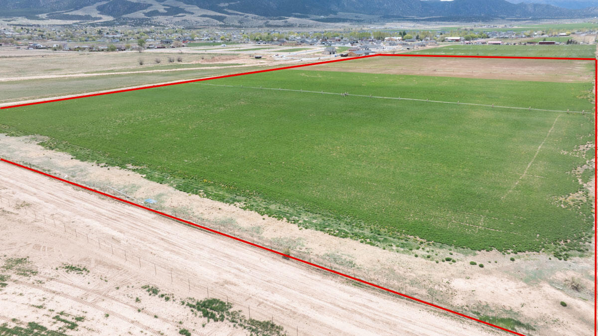 Prime 20-acre parcel in Enoch, zoned R-1-11 with excellent residential development potential. Sale includes 40 acre-feet of agricultural water rights 1936, plus 39 additional acre-feet approved by Enoch City for 39 culinary and pressurized secondary water connections. Flat terrain, mountain views, city utilities nearby, and no HOA. Ideal for subdividing into ¼-acre lots or building a private estate. Convenient location near schools, services, and recreation. A rare opportunity for builders, investors, or those seeking land in a growing area.