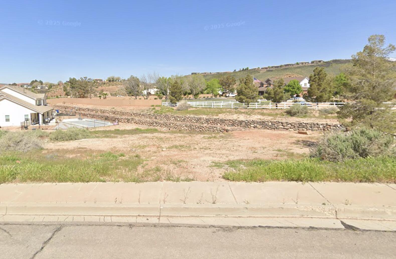 Beautiful quarter-acre walkout lot tucked away on a cul-de-sac in the Washington Benches, elevated above it all with surrounding views and open space. Bike trails are right next door, and the area is bordered by city land, creating a peaceful and spacious setting that's hard to find.
The best part? This lot will be completely pad ready within the next few weeks. The owner is currently building next door and will finish grading this lot to accommodate a similar size and style home, making it truly ready for your build.
Bring your own builder, or we're happy to provide recommendations. Special lots like this don't come around often -- well priced, great location, and ready for your dream home.