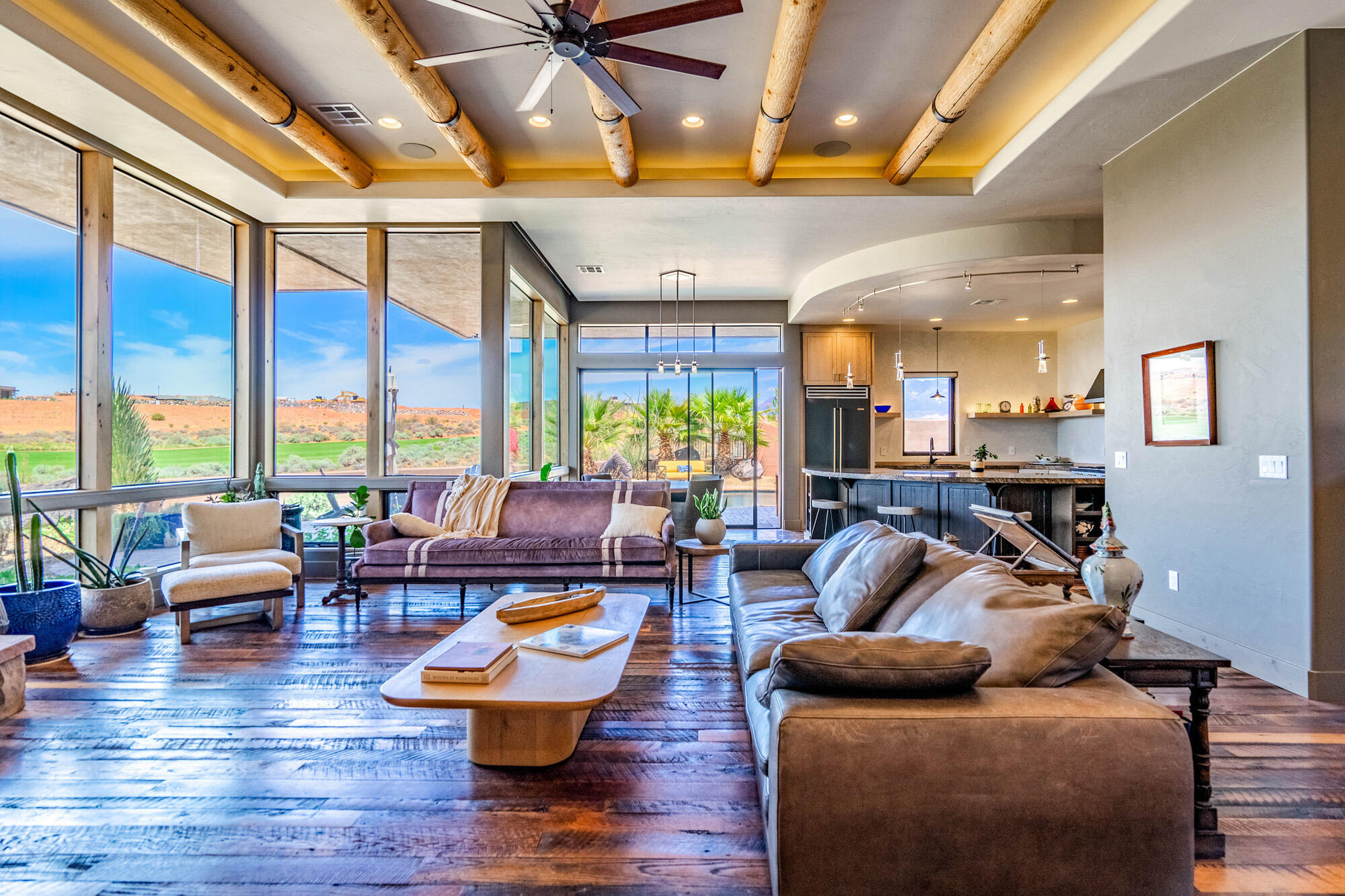 Experience luxury golf course living at its finest in this exceptional custom home perfectly positioned along the 17th fairway of Sand Hollow Golf Course. Designed to capture breathtaking views and seamlessly blend indoor and outdoor living, this residence showcases floor-to-ceiling windows, stunning log beam accents, reclaimed wood flooring, custom granite finishes, and a dramatic gallery hallway that creates an unforgettable first impression.

The gourmet kitchen is thoughtfully designed with a large center island, premium finishes, and generous space for entertaining. The versatile floor plan includes a private casita, dedicated office, exercise room, and flexible basement space ideal for additional storage, hobbies, or a future media room.

Step outside to your own private resort-style retreat featuring a saltwater pool, hot tub, multiple courtyards, and easy-maintenance landscaping. An expansive upper viewing deck offers panoramic 360-degree views of Zion National Park, Pine Valley Mountain, the surrounding red rock landscape, and the award-winning Sand Hollow Golf Course.

The oversized garage includes a workshop area, providing ample space for vehicles, golf carts, toys, and projects. Located within one of Southern Utah's most sought-after golf communities, this extraordinary home offers the perfect combination of luxury, recreation, and unforgettable scenery.