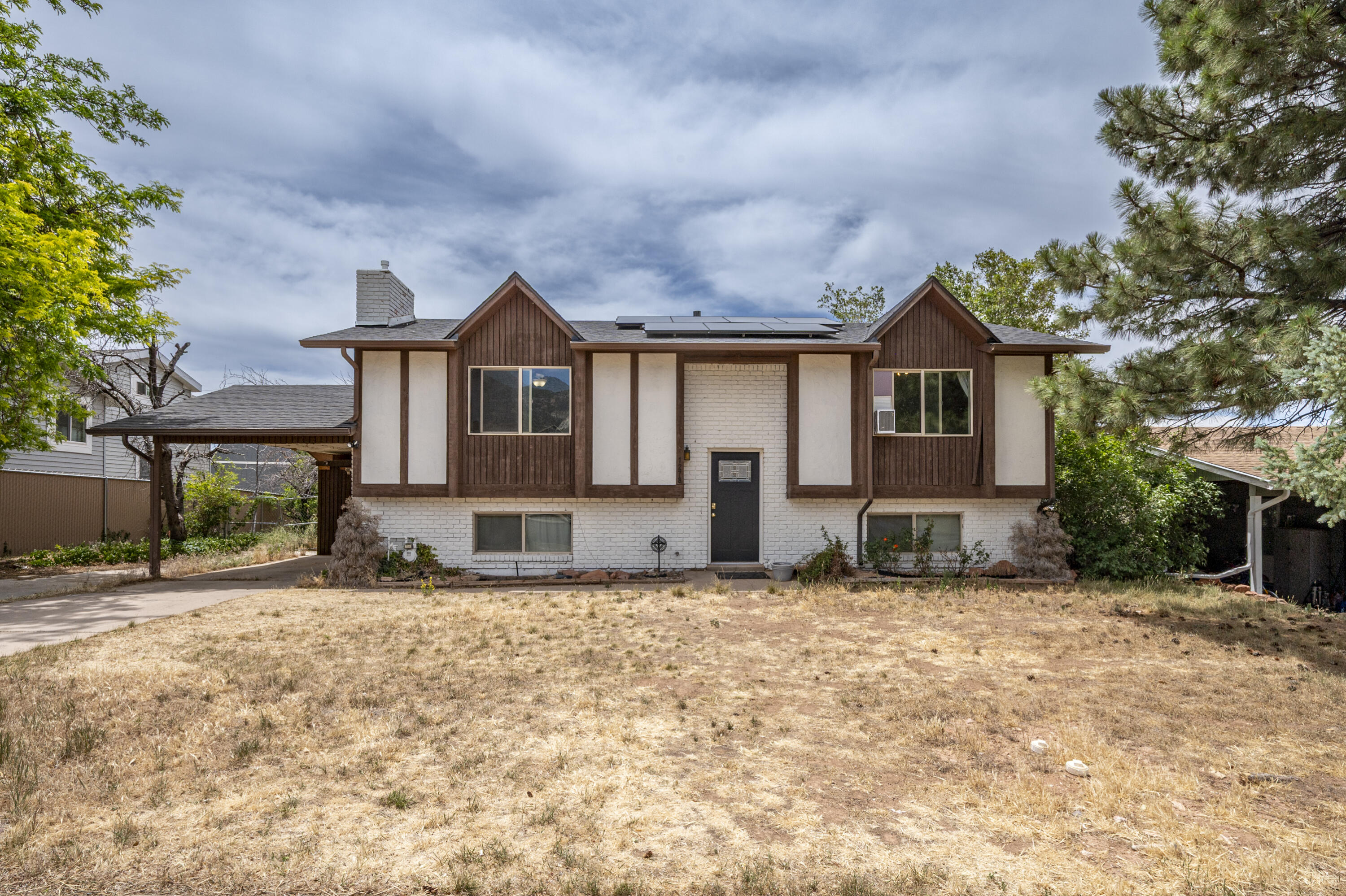 Charming split-level single-family home built in 1976, situated on a spacious 0.35-acre lot in the heart of town. The property features four bedrooms downstairs with a full bathroom and laundry area, while the main floor offers two additional bedrooms and a full bathroom, providing ample space for family and guests. The backyard boasts mature pine trees, fruit trees, and a fenced yard, offering fantastic potential for outdoor activities and gardening. Solar panels are included, enhancing energy efficiency. Located in a central neighborhood, this home combines comfort with great investment potential.