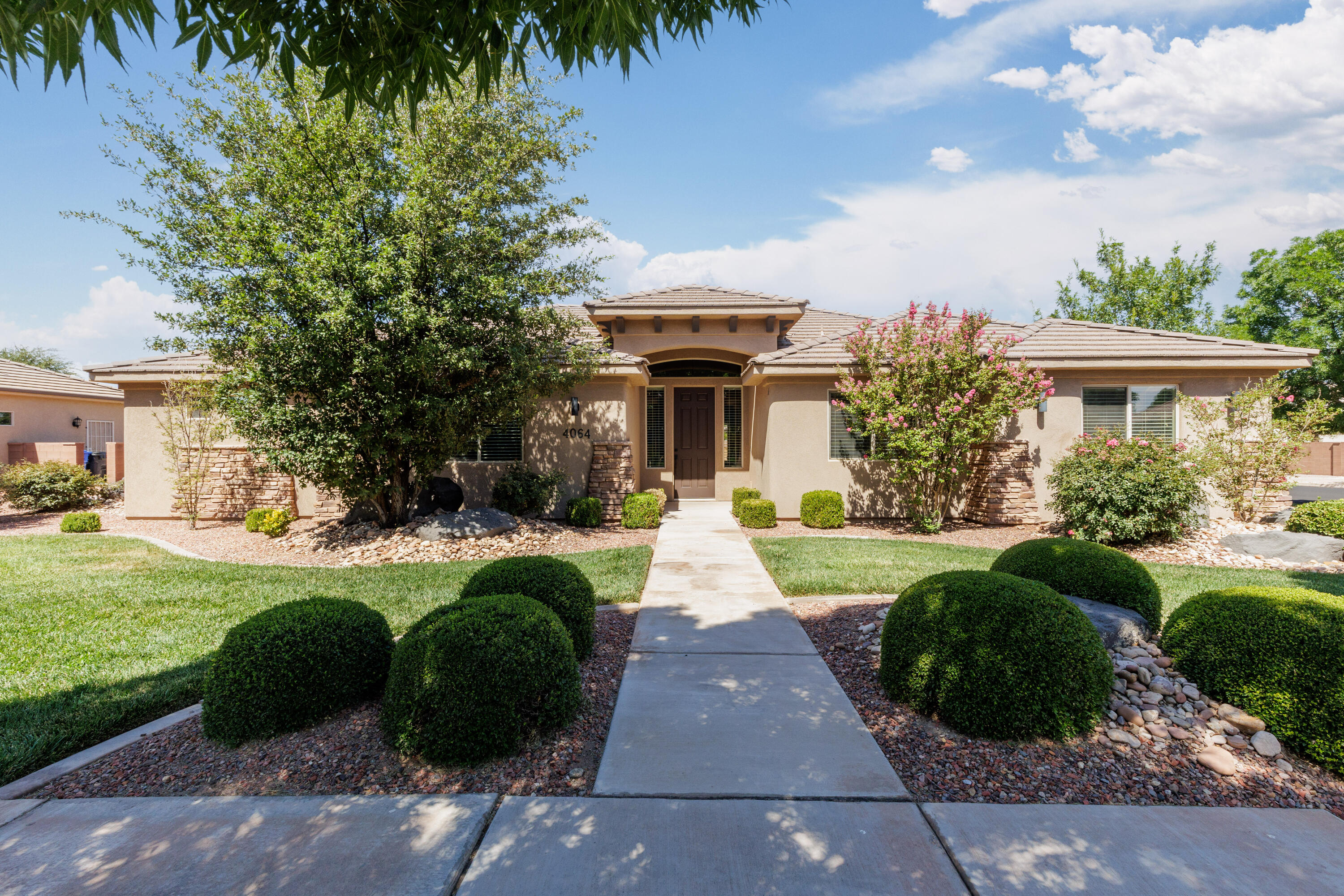 Recently remodeled and updated 4 bed, 2 bath, single level home in the Crimson Cliffs school boundaries. This home features a new expanded kitchen with large island, bar seating, quartz countertops, induction stove and walk-in pantry. New LVP flooring has been installed in the main living areas in addition to new neutral colored paint with white trim. The primary bathroom features a large custom dual head walk-in shower, freestanding soaking tub, double sink vanity and custom closet organizers. The great room is light, bright and open. Perfect for entertaining! The 3 car garage features a mini-split, insulated doors, a 220V outlet and a temporary enclosed clean room area. The secluded, fenced backyard is landscaped to perfection with a grassy area, mature trees & large covered patio. Centrally located and within walking distance to the high school and a large neighborhood park. Don't miss your chance to have a newly updated home in a well established neighborhood.