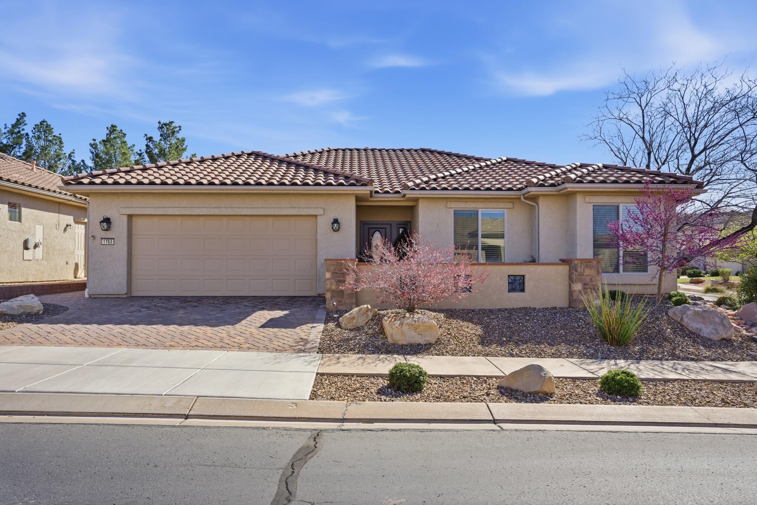 Welcome to effortless living in this beautifully remodeled home located in the beautiful Sun River community, a desirable 55+ neighborhood surrounded by breathtaking red rock landscapes. This stunning 3-bedroom, 2-bath residence has been fully renovated with high-end finishes and thoughtful design throughout. From the moment you arrive, the paver driveway and entry, immaculate landscaping, automatic yard lights, and fully fenced yard create exceptional curb appeal and privacy. A drip irrigation system keeps the landscaping lush while maintaining easy, low-maintenance care. Inside, you'll find a bright, open layout featuring elegant built-ins, crown molding, gorgeous quartz countertops, and a cozy fireplace that anchors the main living space. The kitchen shines with upscale finishes, cupboard and under-counter lighting, and a large kitchen pantry, offering both style and functionality for everyday living or entertaining. A dedicated laundry room adds convenience, while automatic blinds and quality craftsmanship enhance comfort and sophistication throughout the home. Step outside to your private oasis - a fully landscaped backyard complete with a soothing water feature and a large covered patio, perfect for relaxing mornings, evening gatherings, or simply enjoying the stunning red rock views. Additional highlights include a spacious 2-car garage and low-maintenance landscaping designed for easy living. Ideally located just 40 minutes from Zion National Park, you'll enjoy quick access to world-class hiking, biking, and endless outdoor adventures - all while coming home to peaceful community living. This is desert living at its finest - beautifully upgraded, perfectly located, and ready to welcome you home.