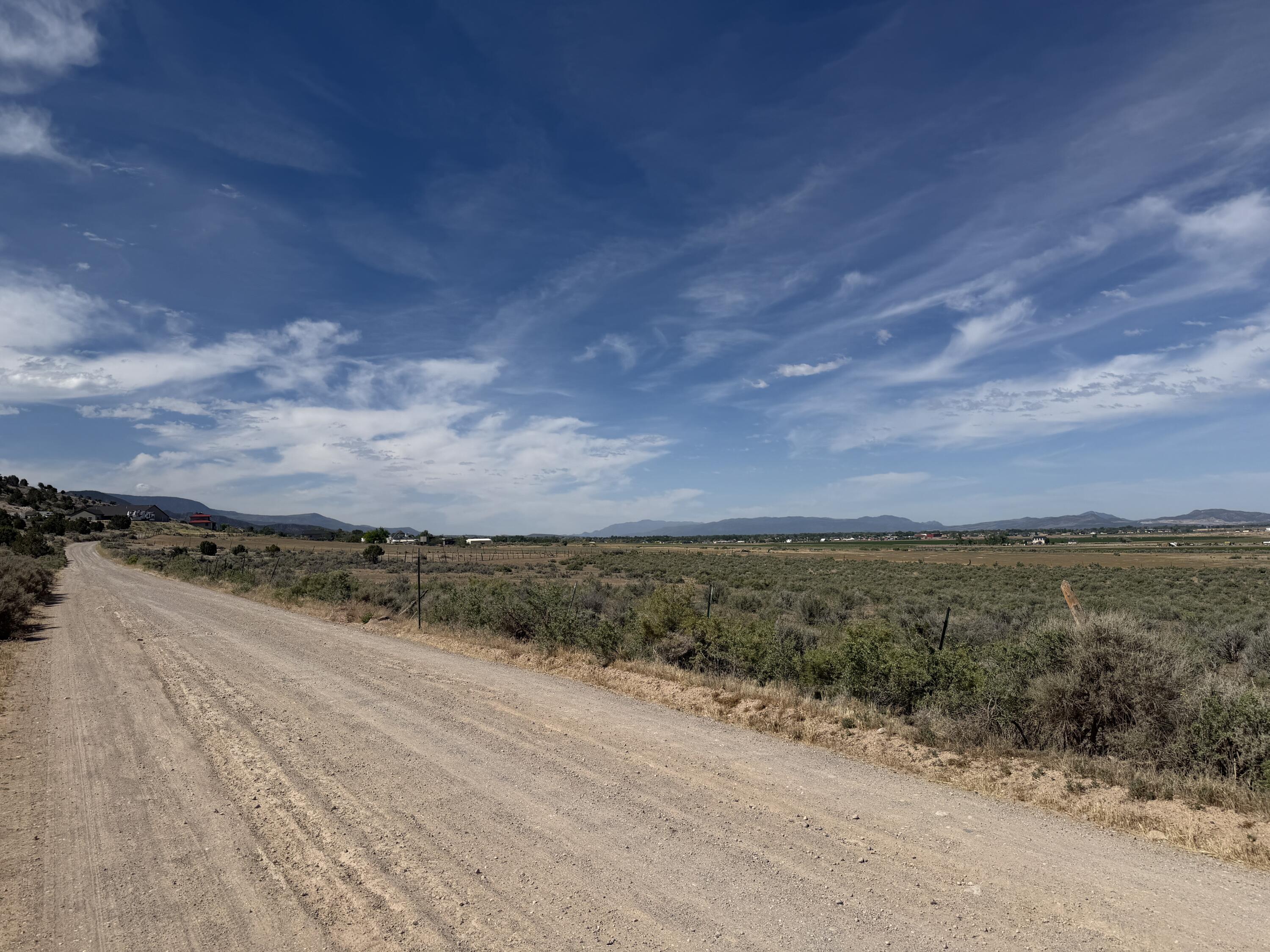 Just under 4 acres, this beautiful property is located at the end of Enoch Road beyond the paved section, offering privacy and a peaceful rural setting. Surrounded by farmland, the elevated building site provides stunning views of the Three Peaks in the distance. With plenty of space and endless possibilities, this is an ideal location for your dream home, hobby farm, or future investment.