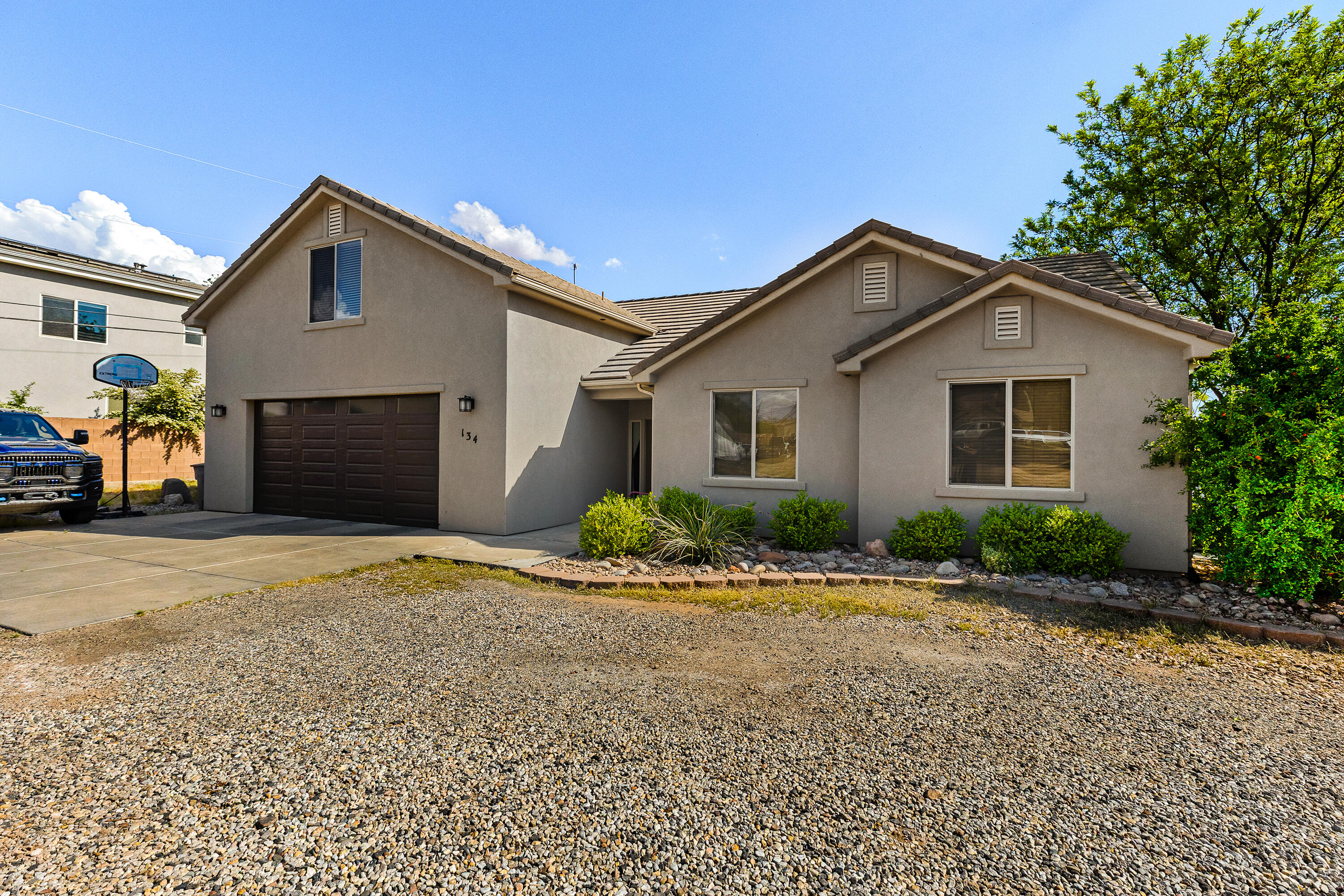 Tucked away on a quiet flag lot in Washington, this 2,684 sq ft two-level home offers privacy, space, and a versatile layout. The main level features a spacious primary suite plus two additional bedrooms, with an open-concept kitchen, dining, and living area perfect for gathering and entertaining. Enjoy granite countertops, a large walk-in pantry, tile and carpet flooring, and abundant storage throughout. Upstairs includes two bedrooms, a full bath, and one of the upstairs bedrooms could double as a  flexible bonus room ideal for a game or family room. Relax under the large covered patio and enjoy the oversized 574 sq ft 2-car garage. Stucco exterior and tile roof add lasting value. Conveniently located just minutes from shopping and dining including In-N-Out Burger, Costco, Walmart, and more.