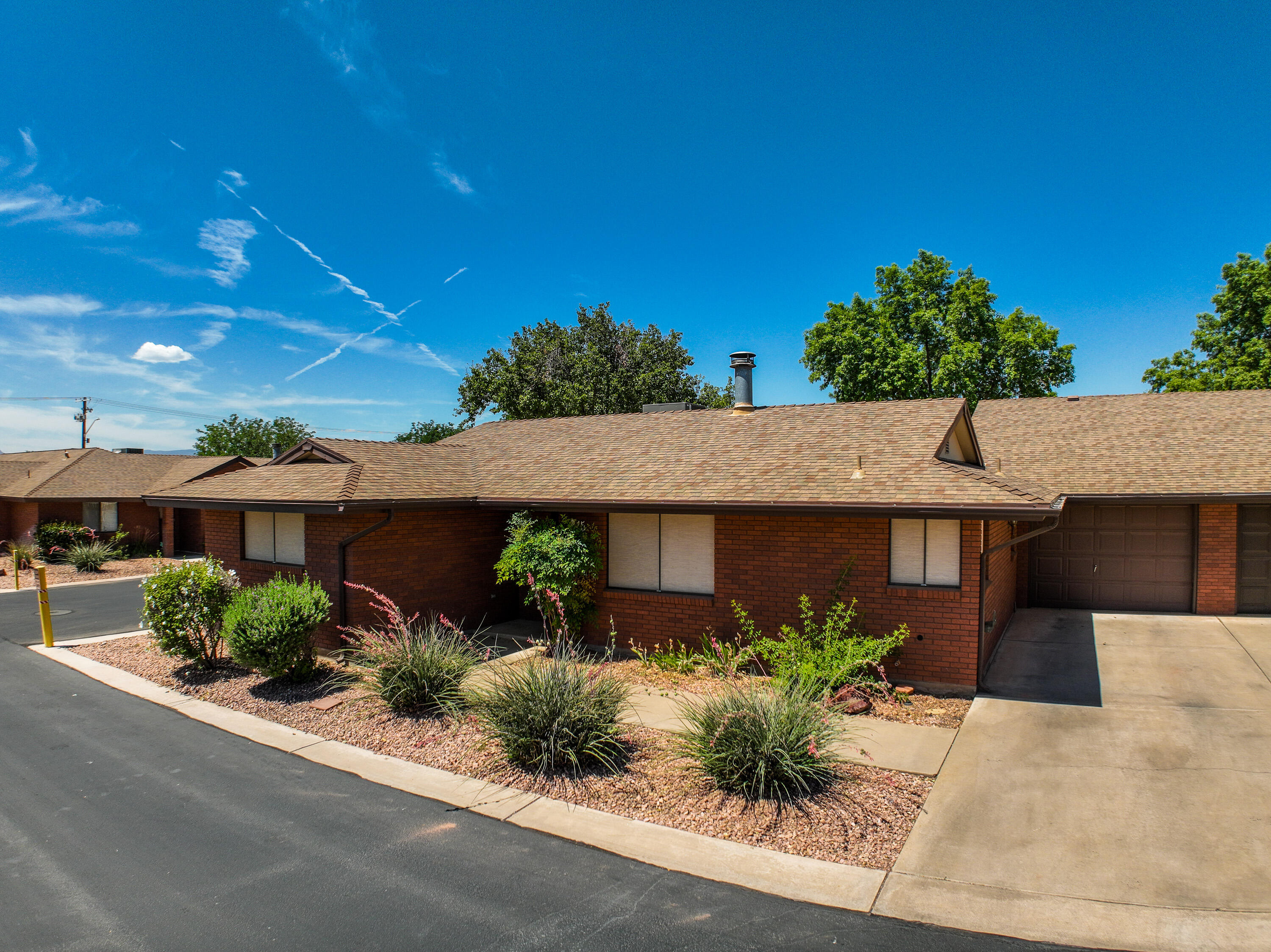 This clean two bedroom two bath has new flooring through out , new window coverings, storage in the garage.