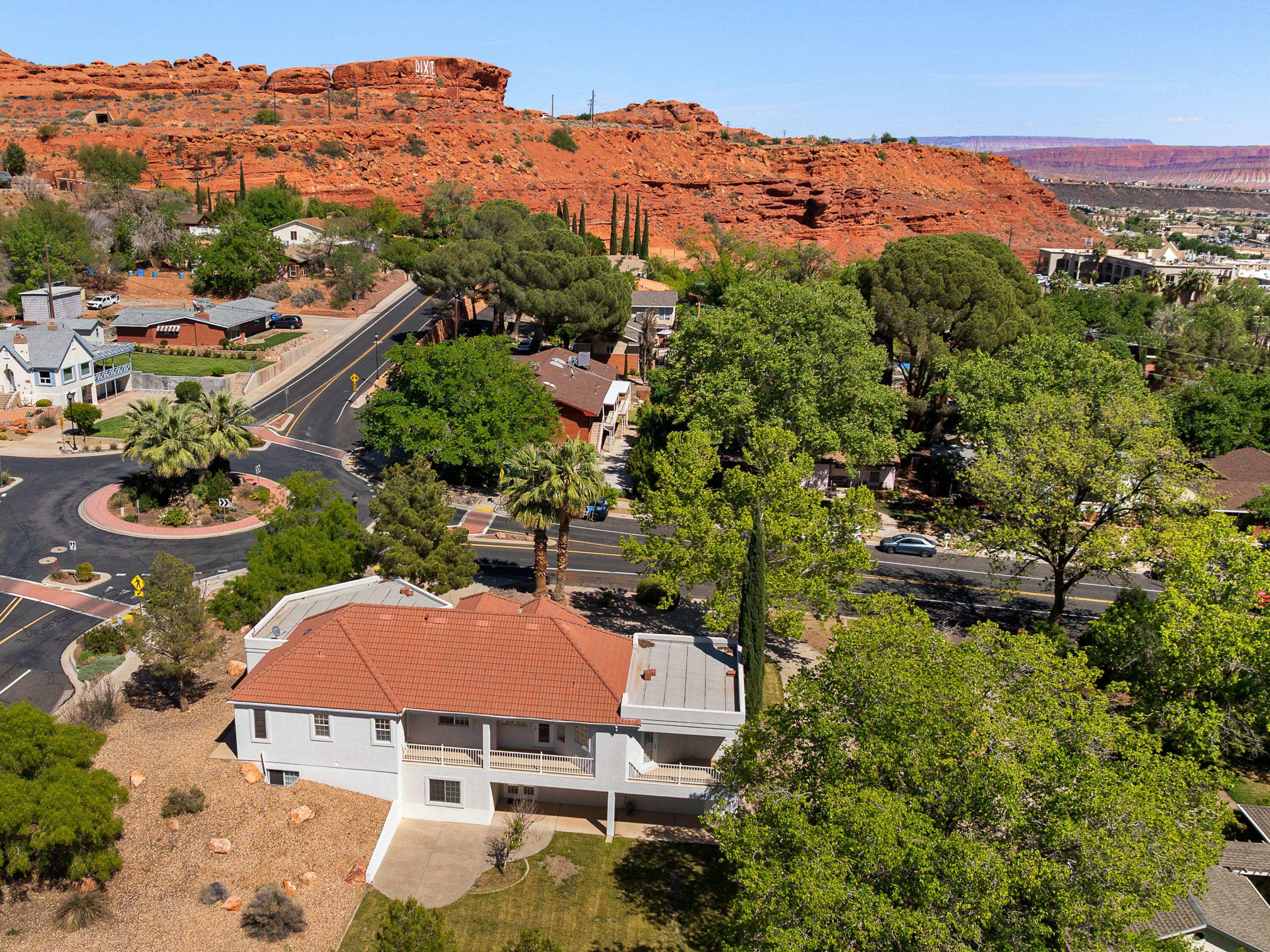Once in a generation. Perched at the very top of Main Street, this iconic hillside home offers sweeping red rock views--enjoyed daily from your kitchen window. Wake up and walk to downtown, Owen's Loop, Dixie Rock, and Pioneer Park--St. George's most sought-after lifestyle right outside your door. Set on a rare 0.40-acre lot, the mature, tree-filled yard creates unmatched privacy, with a huge backyard and room for a pool--your own in-town oasis. Multiple decks and patios invite evenings under the sky. With a walk-out basement, 2nd kitchen, and dual laundry, the home adapts to your life. Opportunities like this don't come twice--secure your place above it all.