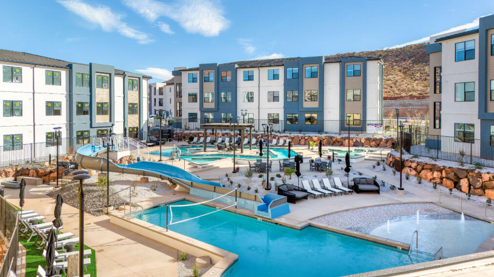 Offered with a furniture package included, this spacious 5-bedroom, 5.5-bathroom condo in Terra's Loft building is truly move-in or rental-ready and provides the perfect home base for adventure and relaxation in Southern Utah. Spread across three stories, this thoughtfully crafted home features open living spaces, modern finishes, and a private rooftop deck with a hot tub-ideal for unwinding after a day of exploring. Enjoy access to resort-style amenities, including a pool, waterslide, lazy river, and pickleball courts, or venture out to Zion National Park, Sand Hollow, and Quail Creek. Whether you're making memories with family or friends, this condo is built for fun and convenience.