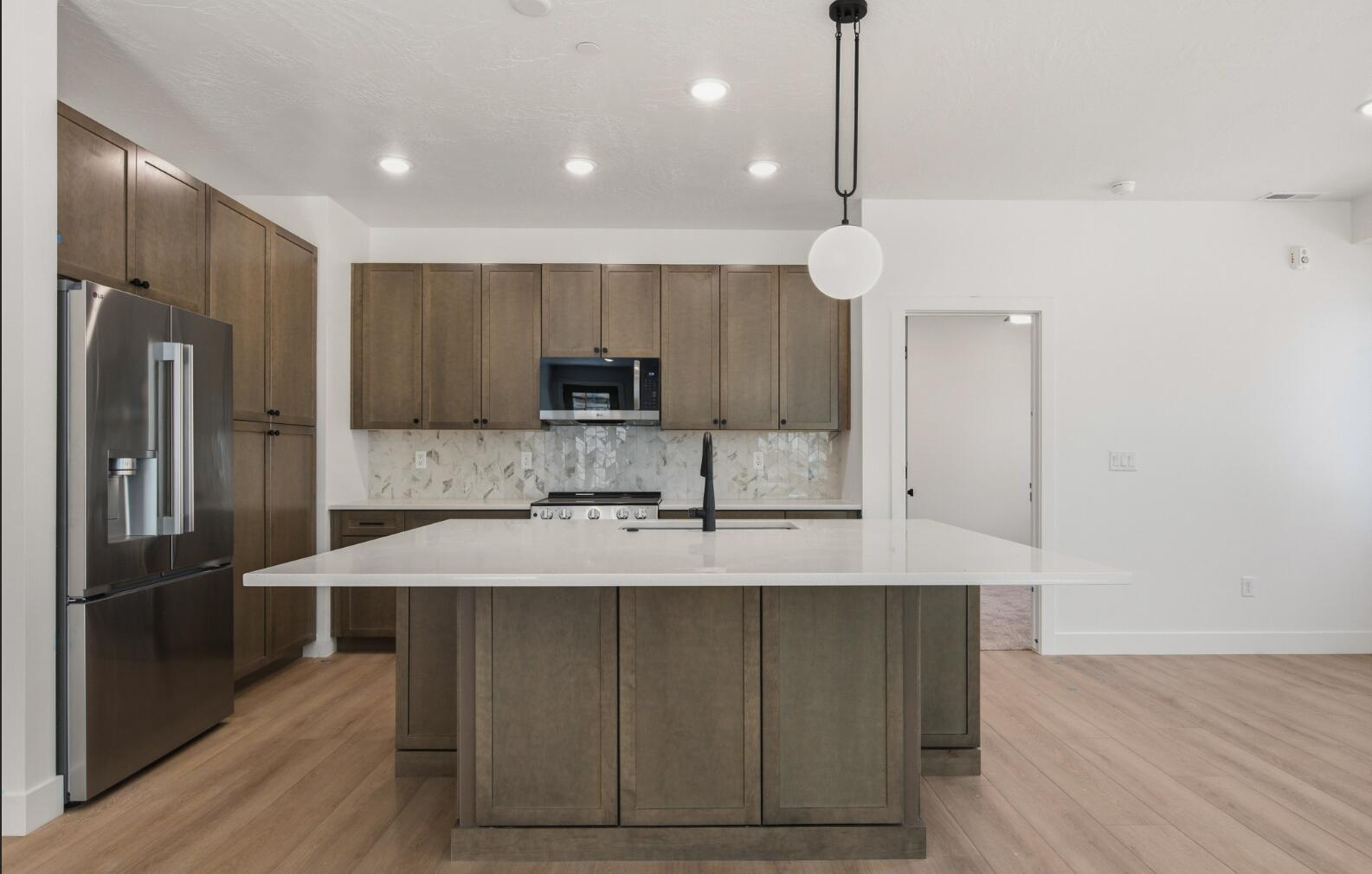 Offered with a furniture package included, this spacious 5-bedroom, 5.5-bathroom condo in Terra's Loft building is truly move-in or rental-ready and provides the perfect home base for adventure and relaxation in Southern Utah. Spread across three stories, this thoughtfully crafted home features open living spaces, modern finishes, and a private rooftop deck with a hot tub-ideal for unwinding after a day of exploring. Enjoy access to resort-style amenities, including a pool, waterslide, lazy river, and pickleball courts, or venture out to Zion National Park, Sand Hollow, and Quail Creek. Whether you're making memories with family or friends, this condo is built for fun and convenience.