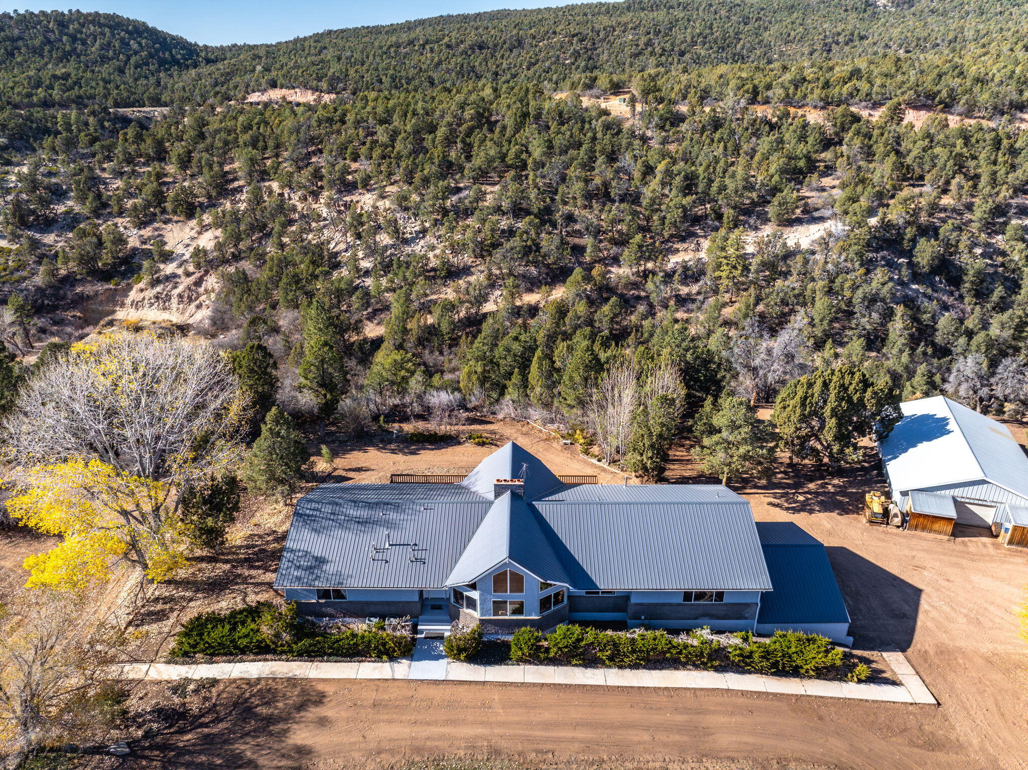 Seller Financing Opportunity. Rare multi-parcel opportunity located on paved North Fork Road, just five miles east of Zion National Park. This exceptional property includes 4 parcels totaling 143+ acres of scenic Southern Utah terrain, highlighted by a private canyon with a natural spring - providing privacy, water, and elevated views throughout the property. The primary 80.2-acre parcel features a 5,343 SF home built in 1990 with 6 bedrooms, 4 bathrooms, a fully finished lower level with second kitchen, large covered patio, expansive deck, garages, and covered parking. Additional improvements include a 2,100 sq/ft detached shop and a 1,368 sq/ft secondary residence. The property includes valuable water assets: 7.40 acre-feet of domestic and irrigation water rights, 12.2 acre-feet of approved pond storage with fish and recreation, and 25,000 gallons of water storage, increasingly rare in Southern Utah. Additional parcels include 52.69 acres with a manufactured home, 10.71 acres of land, and a .25-acre parcel with a water tank.

To Clarify, listing also includes Parcels: 1-9-9-1 , 52.69 AC (1,528 sq/ft manufactured home built in 1980), parcel: 1-9-9-3A (10.71 AC), Parcel: 1-9-4-6A (17,000 Gallon Water Tank on .25 AC)