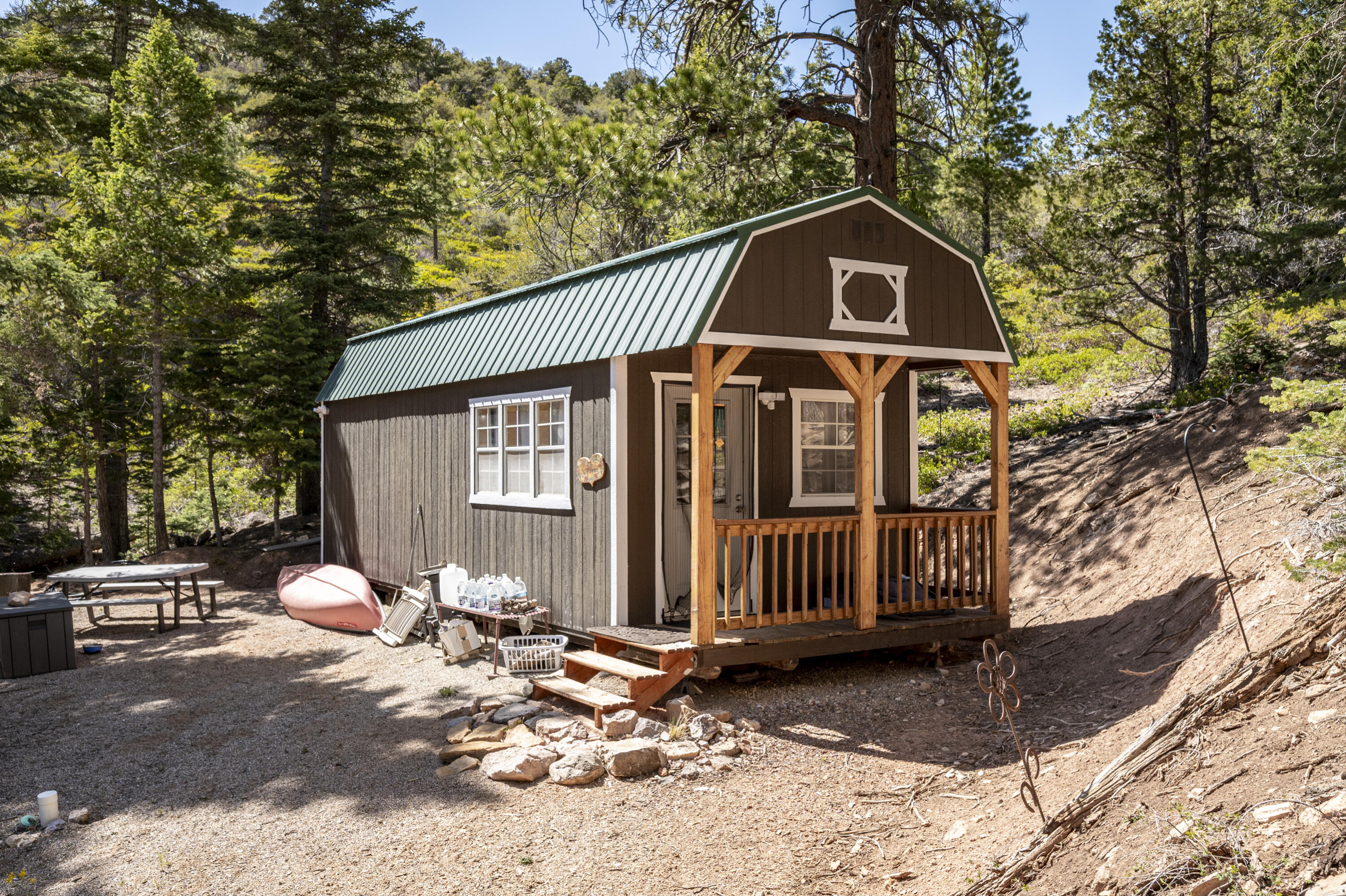 Escape to the mountains and breathe in the cool fresh air on your own 5+ acre retreat! Only 35 minutes from downtown Cedar City, this charming cabin is the perfect getaway spot for weekends, summers, or unplugging from the everyday hustle. Inside you'll find a cozy living area with wood burning stove, bedroom, loft, and bathroom with shower with on demand hot water heater--plus a functional kitchen with sink and a propane refrigerator. Solar power provides electricity for lights and outlets, while a 500-gallon water tank supplies seasonal water needs. Peace, privacy, starry skies, and endless adventure await!