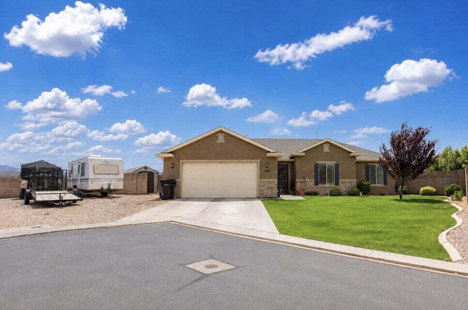 This charming 4-bedroom, 2-bath home offers a bright, open-concept floor plan designed for comfortable everyday living and effortless entertaining. The thoughtfully designed layout features a private primary suite separated from the additional bedrooms, creating a peaceful retreat at the end of the day. One of the secondary bedrooms is exceptionally spacious, making it ideal for a home office, playroom, workout space, or guest suite. Outside, you'll appreciate one of the largest side parking areas in the subdivision, providing ample space for extra vehicles, trailers, toys, or recreational equipment. The backyard captures beautiful views of the Southern Utah mountains, offering the perfect backdrop for relaxing evenings and outdoor gatherings. Just around the corner, residents enjoy convenient access to the community park, making it easy to enjoy green space, recreation, and neighborhood gatherings.

With its functional floor plan, generous parking, mountain views, and prime location, this home is a rare opportunity in the highly sought-after Sycamore Trail community.