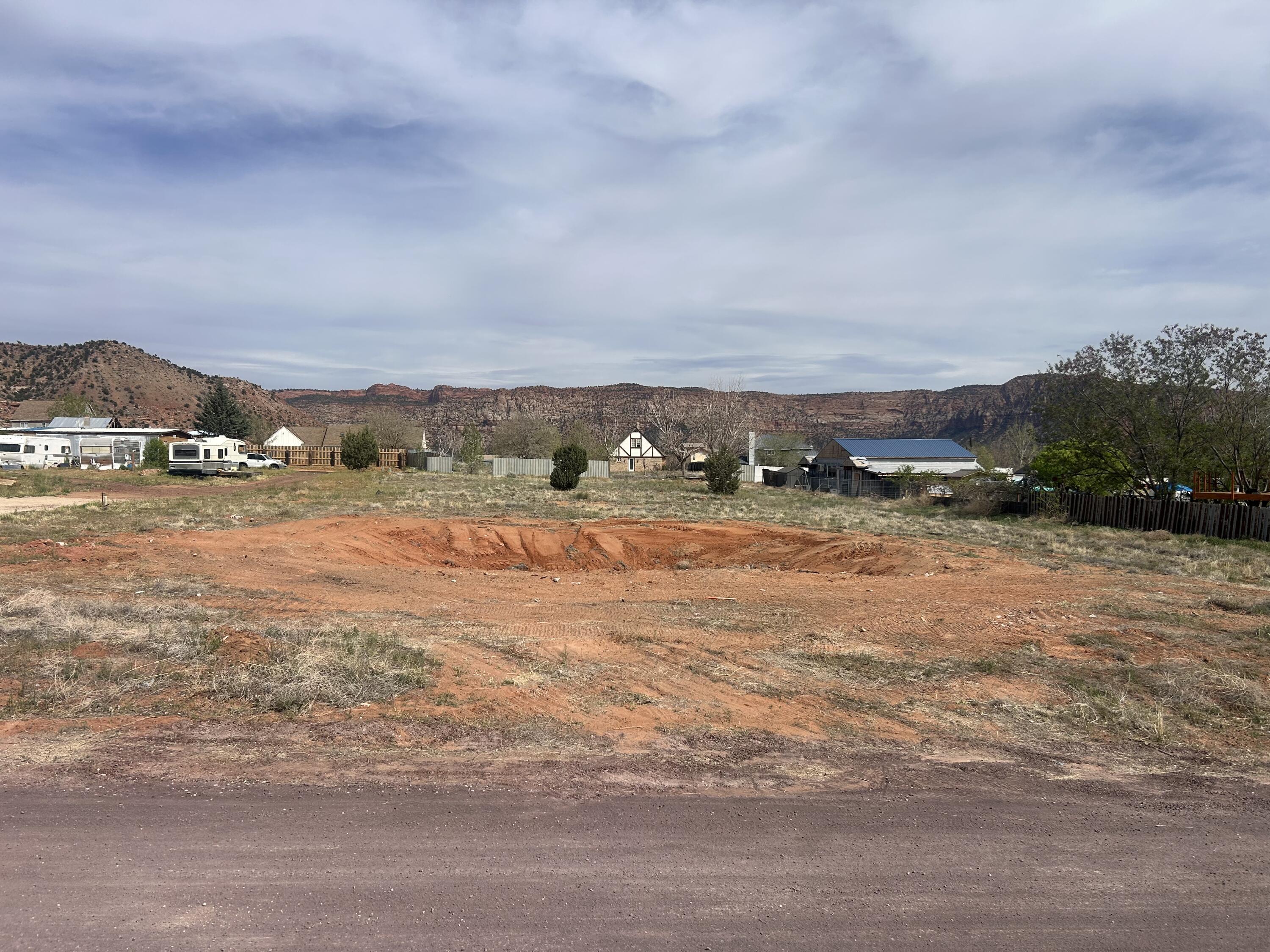 Large Price Improvement!! Foundation has been removed, Rare opportunity to own a flat 0.86-acre buildable lot with unobstructed red cliff views in a new and growing neighborhood. This ready-to-build lot offers natural privacy, a prime location, and easy access to utilities.  Water meter is installed, and water, sewer, and gas fees have been paid, saving buyers significant upfront costs. Most utilities are stubbed to the lot line, making this an ideal site for a custom home.  Seller is motivated and will consider any reasonable offer.