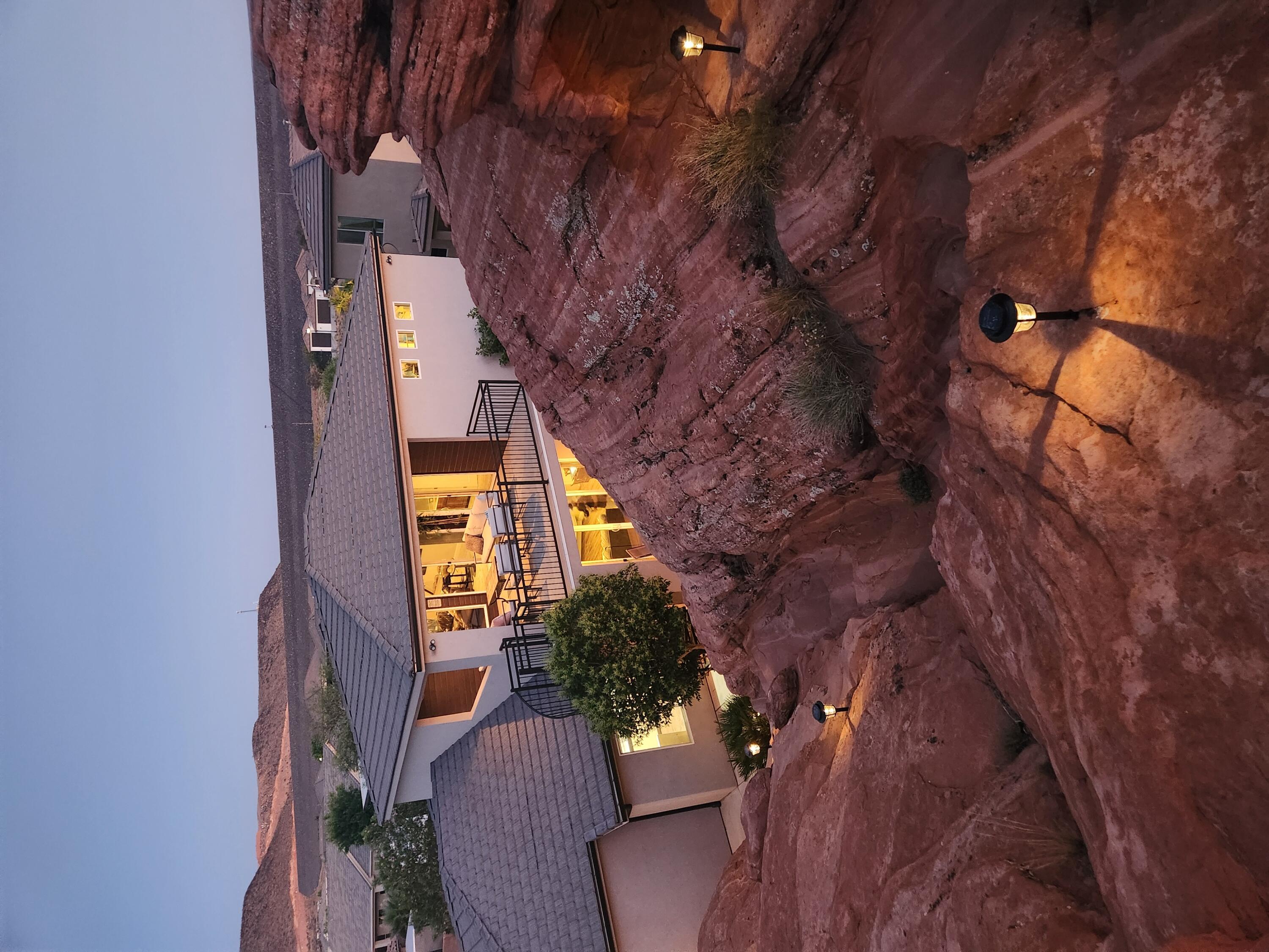 This extraordinary custom-built home is not just carved into the iconic Navajo sandstone�it's built around ''The Rock'' 
The architectural and natural mesh seamlessly blending elevated living with natural beauty of the Southern Utah. Included in this rare offering is a grandfathered, transferable nightly rental license�an invaluable asset, as the city is no longer issuing new licenses.

Designed for high utility and guest satisfaction, the floor plan offers the perfect balance of spacious indoor/outdoor living and guest accommodations. With the ideal bedroom-to-bathroom ratio and multiple gathering spaces, this home is tailored for maximizing both comfort and rental income potential.

NOTE:  Agent is related to the seller, I don't like to admit it, but the DNA is a match and we're both funny look'n!