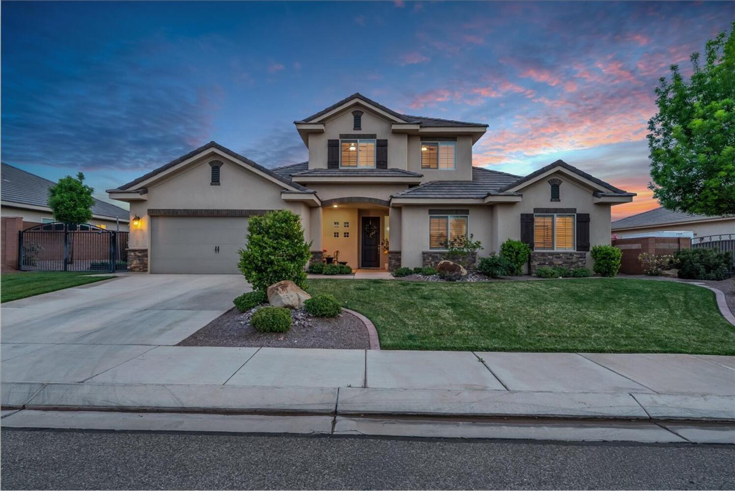 This is the one! A gorgeous Little Valley home with a pool and hot tub, room for the RV, and nearly 3,000 square feet of bright, open living space with six bedrooms and three full baths.
Step inside and you'll notice right away how light and airy this home feels. The open great-room layout flows naturally from the living and dining areas into a beautiful kitchen with a huge granite island that's perfect for snacking, homework, breakfast, you name it. Home chefs will appreciate
the stainless steel appliances and a pantry for extra storage. Large windows throughout frame your view of the lush backyard and pool, making the whole space feel even bigger than it already is. The main-level primary suite is a true retreat with tray ceilings, a walk-in closet with organizers, and a spa-like bath complete with a double-sink vanity, soaking tub, and walk-in shower. Three more bedrooms sit on the opposite side of the main level for added privacy, each
with a ceiling fan and great natural light, plus a second full bath nearby. A mudroom off the garage and a main-level laundry room make day-to-day life that much easier. Head upstairs and you'll find an amazing loft that opens up tons of bonus living space, along with two more bedrooms and a third full bath. Create an office, playroom, guest quarters, home gym, whatever meets your needs. The backyard is really special. A sparkling pool and spa sit at the center of it
all, surrounded by a covered patio with a ceiling fan, a pergola, and a sun sail for extra shade, and a grassy lawn with plenty of room to run around. Privacy walls and beautiful landscaping keep everything feeling tucked away and peaceful. And there's a gated side yard with space for RV parking. The location is hard to beat, right down the street from the local park, bakery, and ice cream shop, and just minutes from Crimson Cliffs High School and Middle School. This one has
it all.