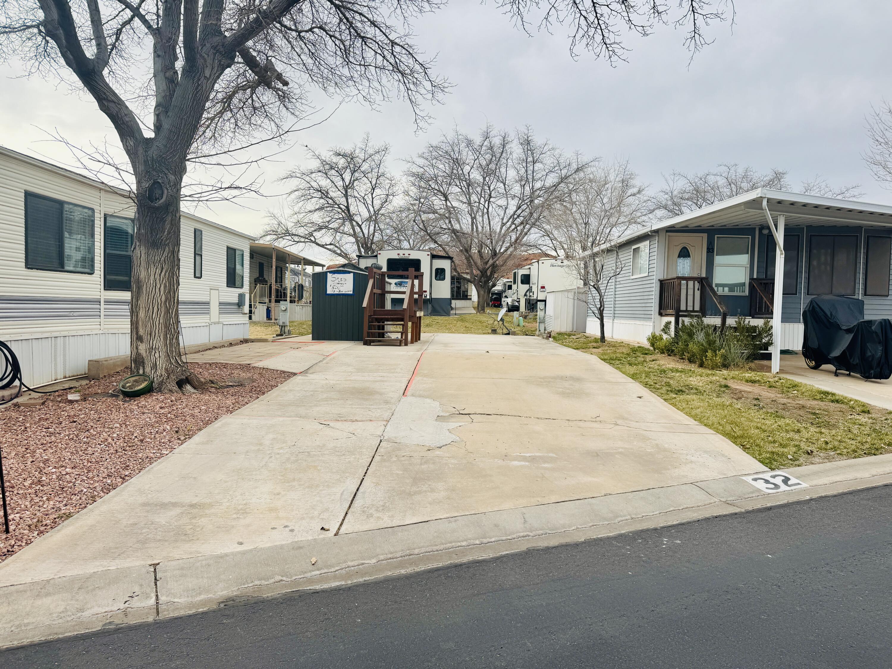 PRIVATE FINANCING! 7% Interest for 15 years. Nestled among the red mountains of Southern Utah, this shaded lot offers a peaceful setting within a desirable 55+ community. The property includes one large shed and is ideally located near shopping, golfing, medical facilities, and scenic walking paths--perfect for enjoying the best of Southern Utah living. Buyer to verify all information.