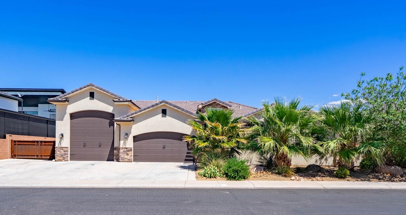 Sharp curb appeal with a 3-car garage, stone accents, and mature desert landscaping sets the tone from the moment you arrive. Inside, the open great room flows into a stunning kitchen featuring rich alder cabinetry, granite countertops, herringbone tile backsplash, stainless appliances, and a large island. A functional mudroom keeps things organized off the garage entry. Primary en-suite with access to the patio, walk-in shower, separate tub and large walk-in closet. Step outside and the backyard showcases a private pool with waterslide and boulder feature, hot tub, pool house, and a large covered patio all tucked behind a private wall of towering palm trees. No HOA, RV garage, and additional RV parking make this one truly hard to beat. Vacant, clean, and easy to show.