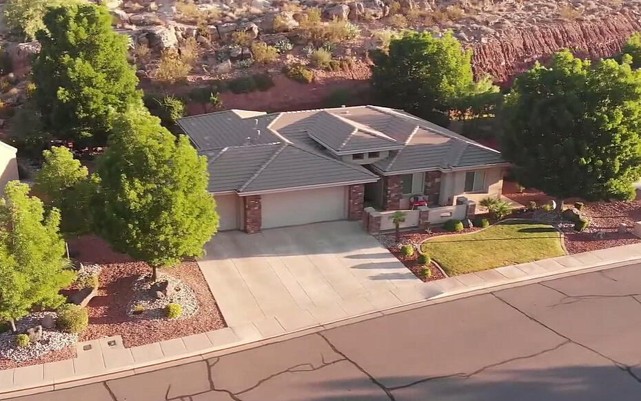 This beautifully maintained 3-bedroom, 2-bath home offers 1,954 sq. ft. of comfortable living on a .24-acre lot surrounded by Southern Utah's stunning red rock scenery. Featuring rich wood cabinetry, granite countertops, stainless steel appliances, plantation shutters, and a spacious open floor plan, this home blends quality craftsmanship with everyday comfort.
The generous primary suite includes a dual-sink vanity, soaking tub, and plenty of space to unwind. A floor-to-ceiling stone fireplace anchors the inviting living room, while large windows fill the home with natural light and views of the beautifully landscaped yard. Complete with a 3-car garage and a peaceful setting, this move-in-ready home is the perfect combination of comfort, style, and location.