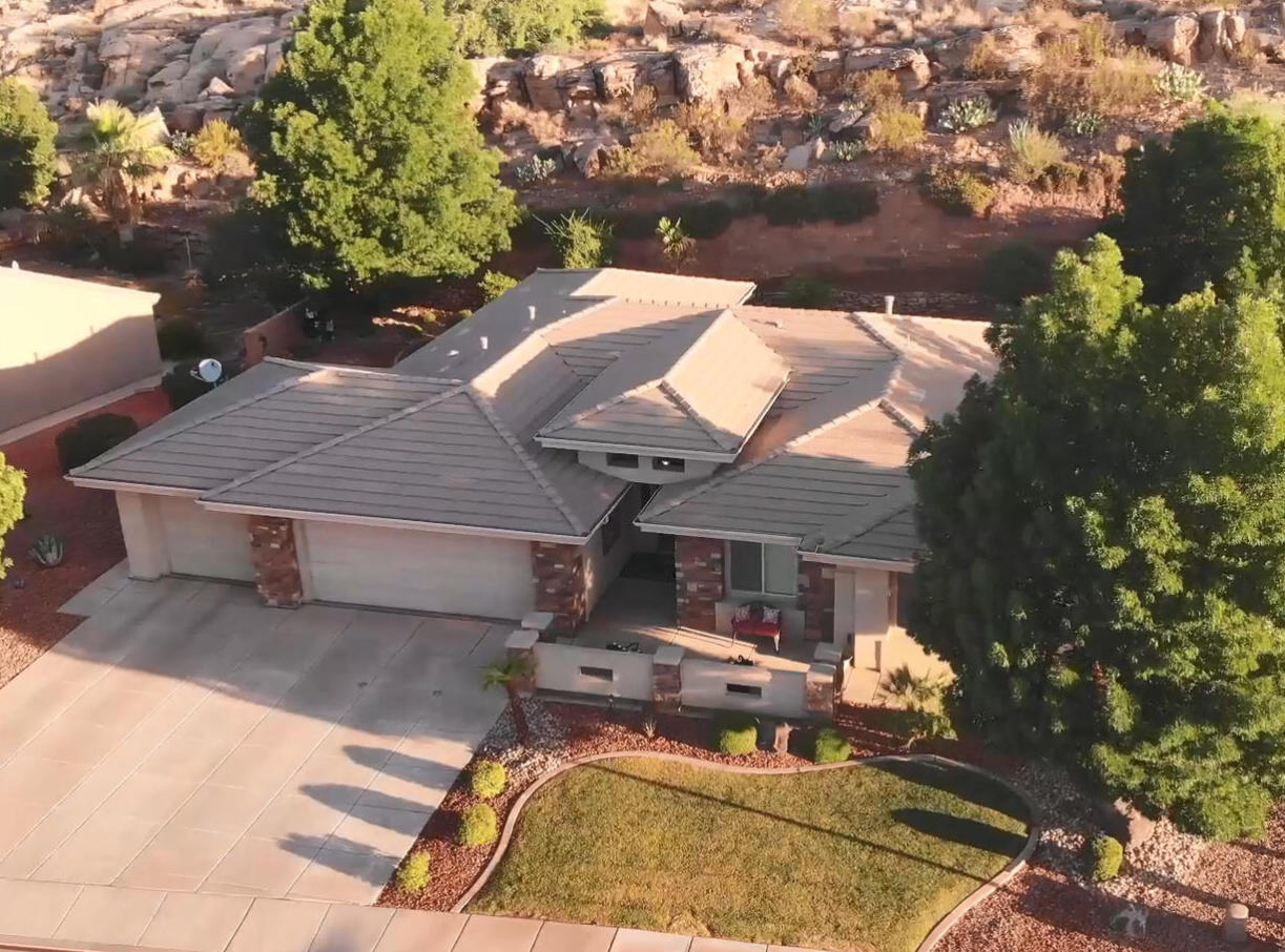 This beautifully maintained 3-bedroom, 2-bath home offers 1,954 sq. ft. of comfortable living on a .24-acre lot surrounded by Southern Utah's stunning red rock scenery. Featuring rich wood cabinetry, granite countertops, stainless steel appliances, plantation shutters, and a spacious open floor plan, this home blends quality craftsmanship with everyday comfort.
The generous primary suite includes a dual-sink vanity, soaking tub, and plenty of space to unwind. A floor-to-ceiling stone fireplace anchors the inviting living room, while large windows fill the home with natural light and views of the beautifully landscaped yard. Complete with a 3-car garage and a peaceful setting, this move-in-ready home is the perfect combination of comfort, style, and location.