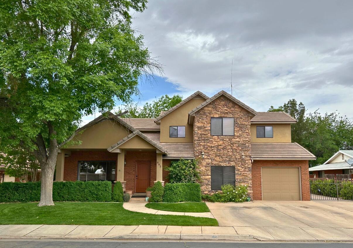 Beautiful remodeled 2 Story home in the heart of St. George! Located in the coveted Morningside Park Community, right in Downtown, you'll love the quick access to shopping, restaurants, Utah Tech, trails, and more! This home offers an open floor plan with huge windows and tons of natural light. Custom features include a large living room with vaulted ceilings, wood floors, doors, trim and banister. Beautiful cabinetry and granite are throughout the spacious kitchen, laundry room, and bathrooms. The master suite features a gas fireplace, deck, two closets, double vanity, shower, and jetted tub. This home offers additional rooms, including a 2nd family room with a gas fireplace, formal dining room, theater room, and bedroom attached to a multi-purpose room which could be used as a 2nd primary suite. Outside, you'll love the fully fenced yard with patio and mature landscaping including nearly a dozen fruit trees, gated RV Parking, and 1.5 car detached garage/workshop. No HOA. Incredible community. Schedule your private showing today.