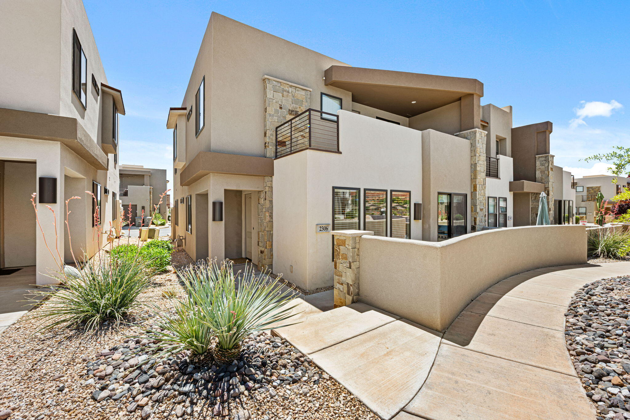 Turn-key short term rental in Town Center at Coral Canyon! This modern and fully furnished property offers an open-concept layout, plenty of natural light, and  5 bedrooms with 4 bathrooms. The spacious kitchen features quartz countertops, modern cabinetry, stainless steel appliances, and a large island ideal for entertaining. Enjoy two private covered patios with beautiful mountain views, including an upper-level deck complete with a hot tub and lounge area. The community offers resort-style amenities and is conveniently located near; Zion National Park: 32 miles away, Snow Canyon State Park: 24 minutes, Sand Hollow, Pioneer Park, and Quail Lake State Park: 5-minute drive. Downtown St. George: 10 minutes away. Whether you're looking for an investment property, vacation home, or weekend getaway, this low-maintenance retreat is ready to go with income potential and modern desert style throughout.