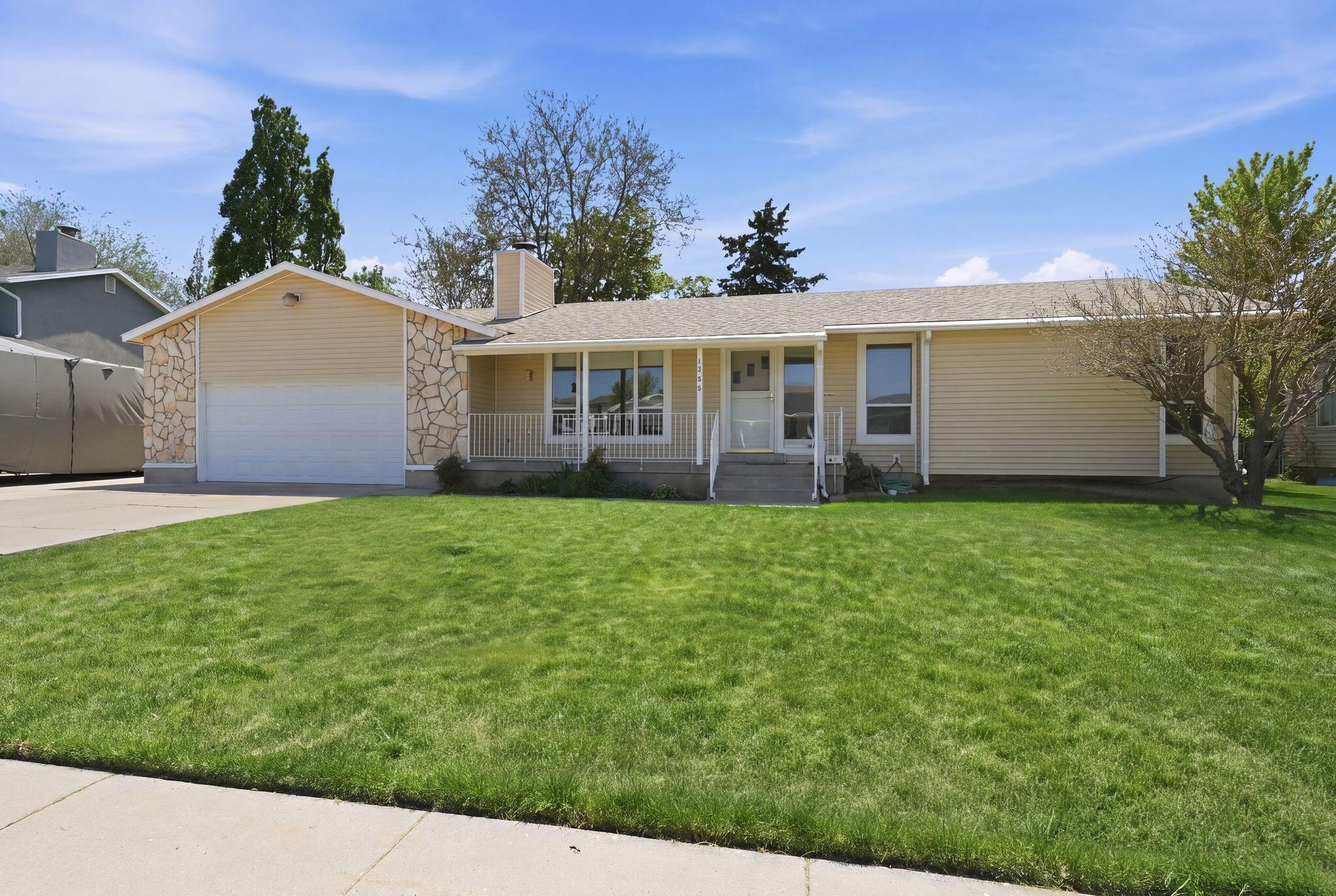 Welcome to this beautifully maintained rambler offering comfortable single-level living with additional space to spread out downstairs. Situated on a spacious lot with mature trees and a fully fenced backyard, this home features inviting curb appeal, a covered front porch, and a large covered back deck perfect for relaxing or entertaining. Inside, you'll find vaulted ceilings, abundant natural light, updated flooring, and a warm living room with a charming fireplace. The fully remodeled kitchen showcases updated cabinetry, countertops, stainless steel appliances, a center island and abundant storage. The primary suite includes an updated bathroom and spacious layout, while the finished basement provides an additional family room ideal for movie nights, a game room, or extra living space. Conveniently located near shopping, schools, parks, and commuter access, this home combines comfort, functionality, and pride of ownership throughout