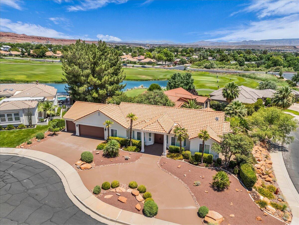 Perched on a corner lot in a quiet cul-de-sac within the highly sought-after Green Springs golf community, this custom single-level home showcases breathtaking views of Zion National Park, Pine Valley Mountain, and the surrounding valley.  The thoughtfully designed floor plan features vaulted ceilings, expansive picture windows, and an open-concept living area that captures the scenery from nearly every room. The spacious primary suite includes a private covered patio, creating the perfect place to enjoy the views and unwind. An oversized 3-car garage provides ample space for storage and larger vehicles, while the circular driveway offers added convenience and curb appeal. Ideally located just minutes from shopping, restaurants, and freeway access--with no HOA fees.