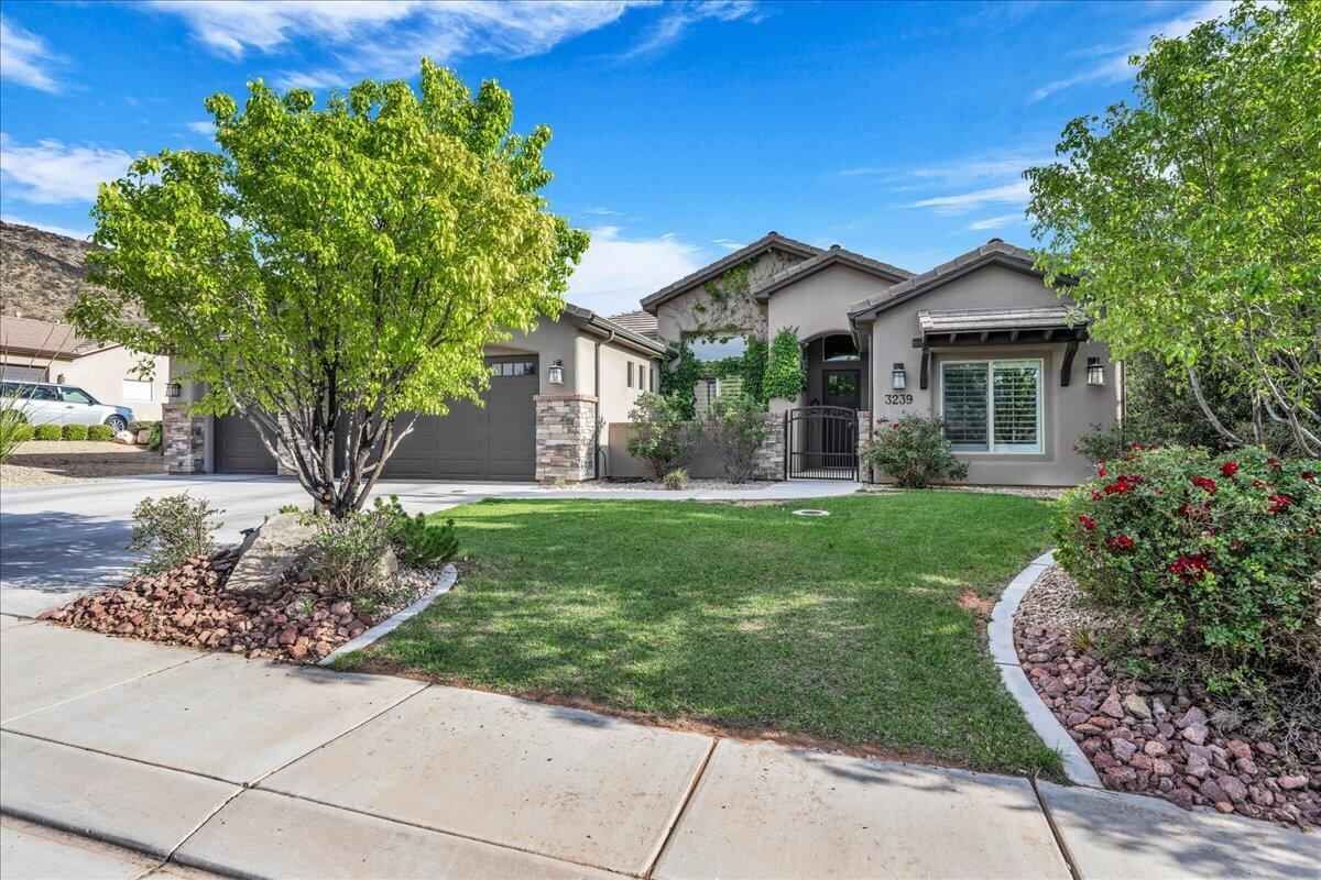 This stunning four-bedroom home is tucked away in a quiet corner of Dixie Springs. It boasts an inviting open floor plan accented by beautiful brickwork, box beam ceilings, plantation shutters, soft close cabinets and a built in vacuum. The beauty extends outdoors with a private courtyard with water feature, mature landscape, large covered patio and permanent holiday lighting. Dixie Springs is a very desirable community as it's located minutes from Sand Hollow Reservoir, golf courses and ATV trails.