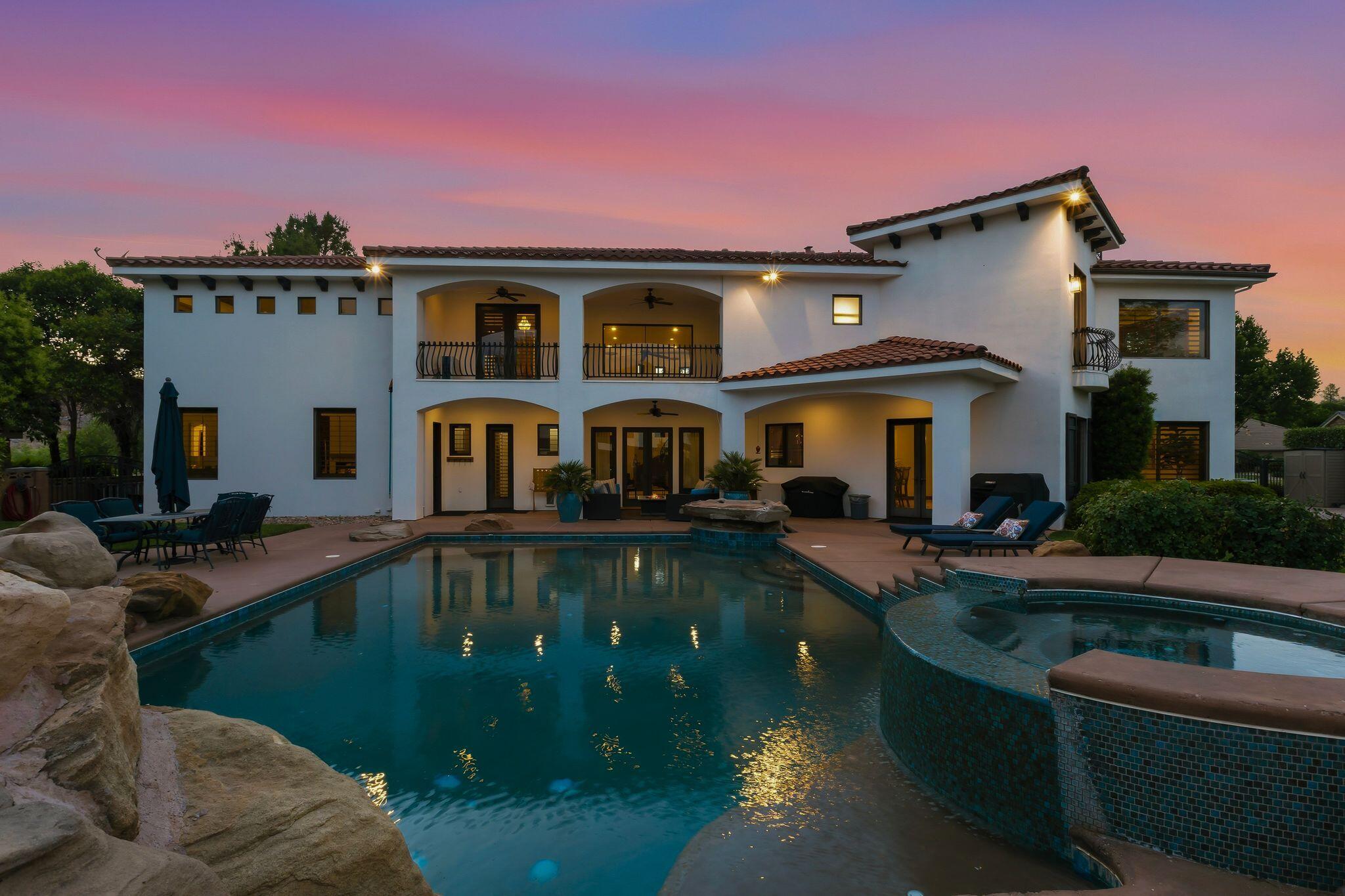 Nestled within the prestigious Vineyards at Santa Clara subdivision, this extraordinary custom-built Mediterranean estate offers luxury living at its finest. Situated on an expansive half-acre lot, this fully upgraded masterpiece is designed to impress even the most discerning buyer. From the moment you arrive, you'll be captivated by the stunning architecture and lush landscaping that transform the property into a true desert oasis. Elegant outdoor water features and a beautiful courtyard warmly welcome you into a home designed for unforgettable gatherings with family and friends.

Inside, no detail has been overlooked. The gourmet kitchen is a chef's dream, outfitted with premium Sub-Zero and Wolf appliances, dual dishwashers, and gorgeous new Taj Mahal quartzite countertops. Recent upgrades seamlessly blend timeless elegance with modern convenience throughout the home. The impressive two-level primary suite offers a luxurious private retreat featuring a spa-inspired bathroom with a jetted soaking tub, dual vanities, an oversized walk-in closet, and custom built-ins. On the main floor, you'll also find a spacious flex room, perfect for a home office, gym, or private study.

Upstairs boasts four additional bedrooms, three with en suite bathrooms, along with a theater room built for the ultimate entertainment experience. The property also includes a beautiful detached guest casita with its own private entrance, kitchenette, laundry facilities, and full-size bathroom--ideal for guests, multigenerational living, or extended stays.

As you make your way to the backyard, you'll discover a true private resort complete with a stunning custom in-ground swimming pool, relaxing hot tub, and cascading water features. Whether entertaining on a grand scale or simply unwinding in complete privacy, this remarkable property perfectly combines luxury, comfort, and functionality in one of Southern Utah's most sought-after communities.