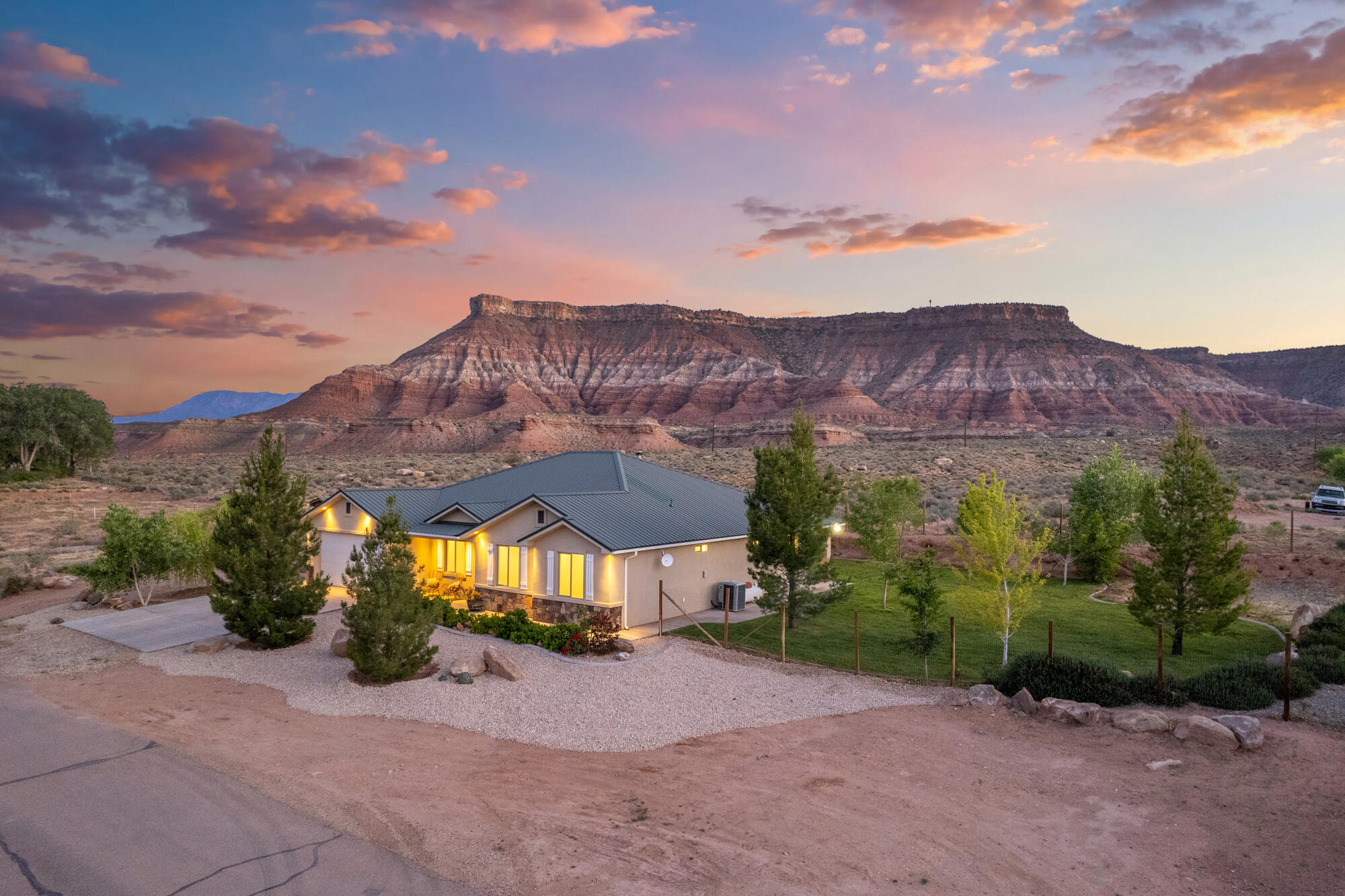 This 4-bedroom home on 0.59 acres offers the ultimate Southern Utah basecamp, backing directly to BLM land with unobstructed red rock views. Located on a quiet street walkable to town and the Virgin River, you have adventure at your doorstep--from world-class hiking and biking to endless off-roading trails right out your back gate. The property is fully equipped for gear and toys, featuring a two-car garage with built-in storage, a tool shed, and expansive RV parking with hookups and a cleanout. With Zion National Park minutes away and a private, fenced yard to return to, this is a rare opportunity to own a piece of Virgin's tranquil beauty.