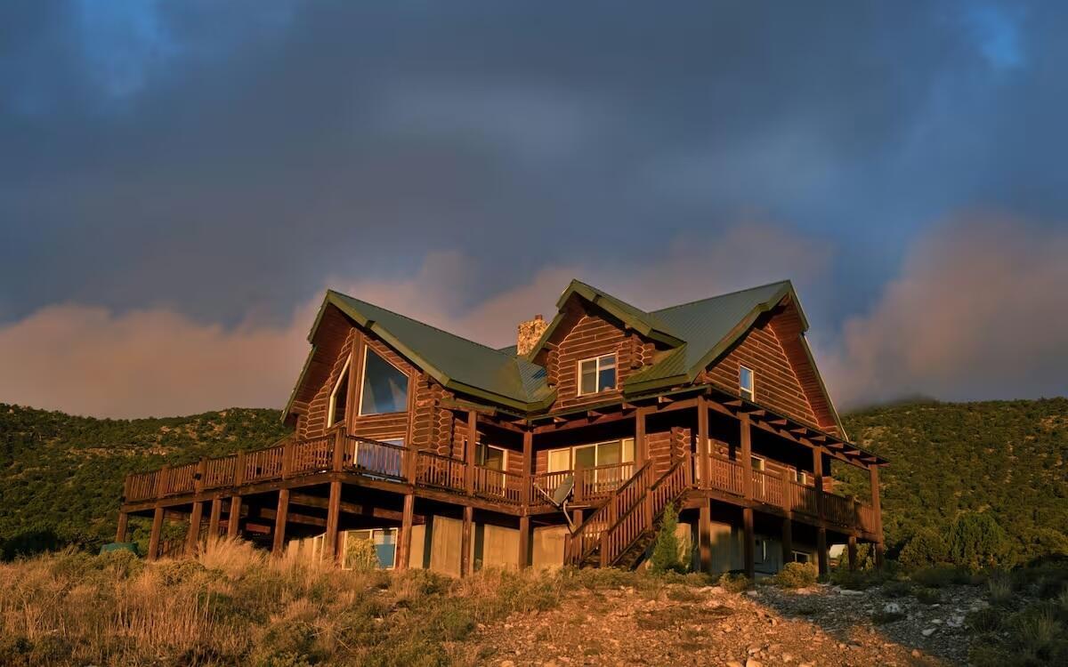 Escape to this fabulous three story cabin secluded in the Wah Wah Mountains in northwest Iron County. This amazing custom lodge is nearly 6,000 square feet and built on 840 tree-covered acres. Completely surrounded by BLM land for outdoor recreation enthusiasts. Spectacular views from everywhere on the property. Clear views of Brianhead, Cedar Mountain, Kolob, and the lights of Cedar City. The 1296 sq. ft. wrap-around deck sports a staircase on each side. You'll love the large family room which features an incredible ceiling-high stone fireplace. Unique ceiling angles and beams add interest to the pine tongue and groove vaulted ceiling. Large kitchen with custom pine cabinetry. Commercial grade stainless steel six-burner gas stove with 24'' grill and double ovens. This home has it's own Solar power and all the modern conveniences but with seclusion and peace and quiet provided by the gorgeous countryside all around this gorgeous retreat! Call agent to get all the details there are too many to share!