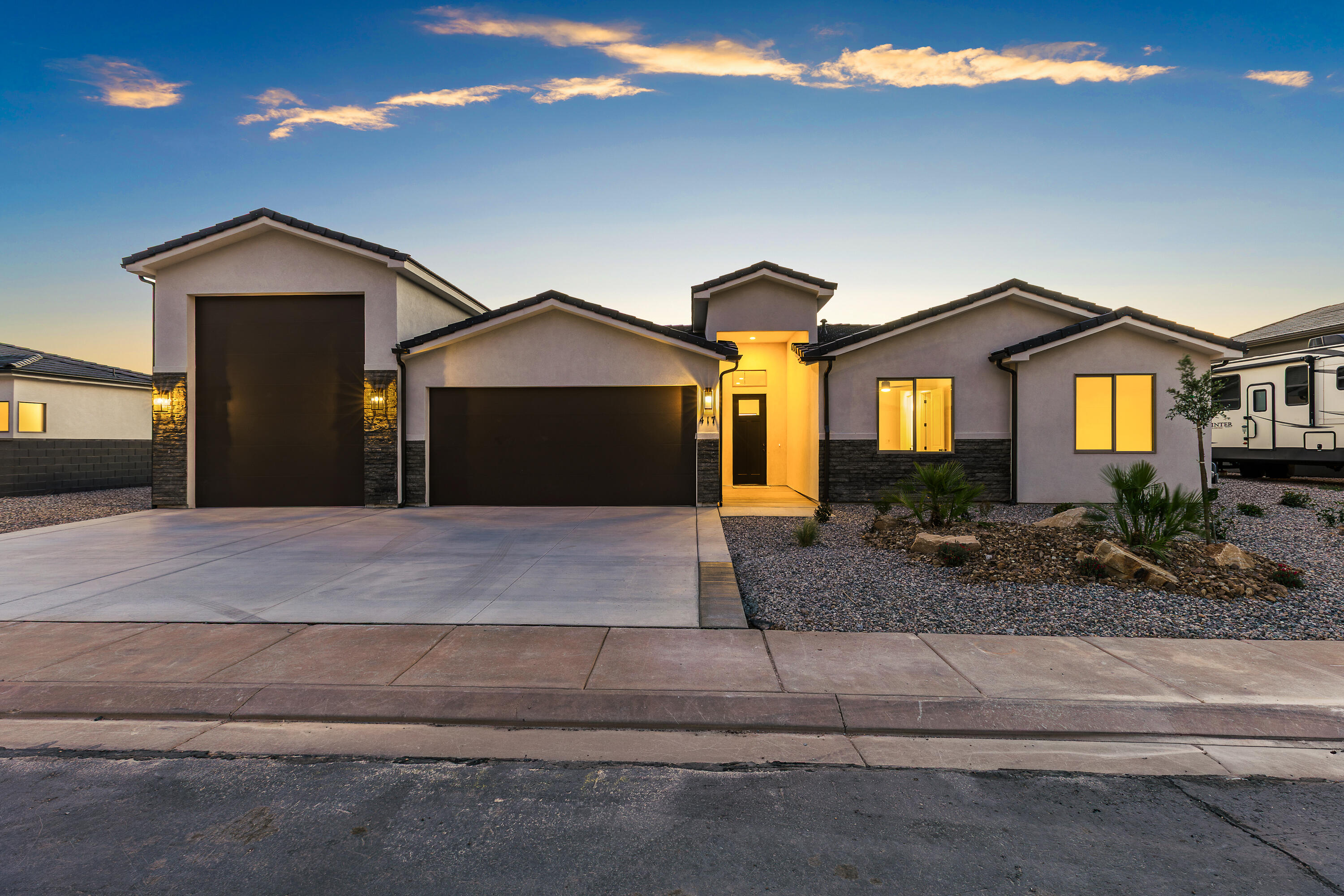 Modern design, open layout, and plenty of room for storage, toys, or adventure-ready living. The RV Garage features a 12' wide door with 14' of height with the depth a little over 48'. The kitchen features quality wood cabinets, quartz countertops, and black plumbing fixtures. The large island is perfect for entertaining. The primary suite offers a walk-in closet and unobstructed view of Pine Valley Mountain. Enjoy the convenience of single-level living with stylish touches and ample storage for everything you need. Contract the listing agent to schedule your showing today.