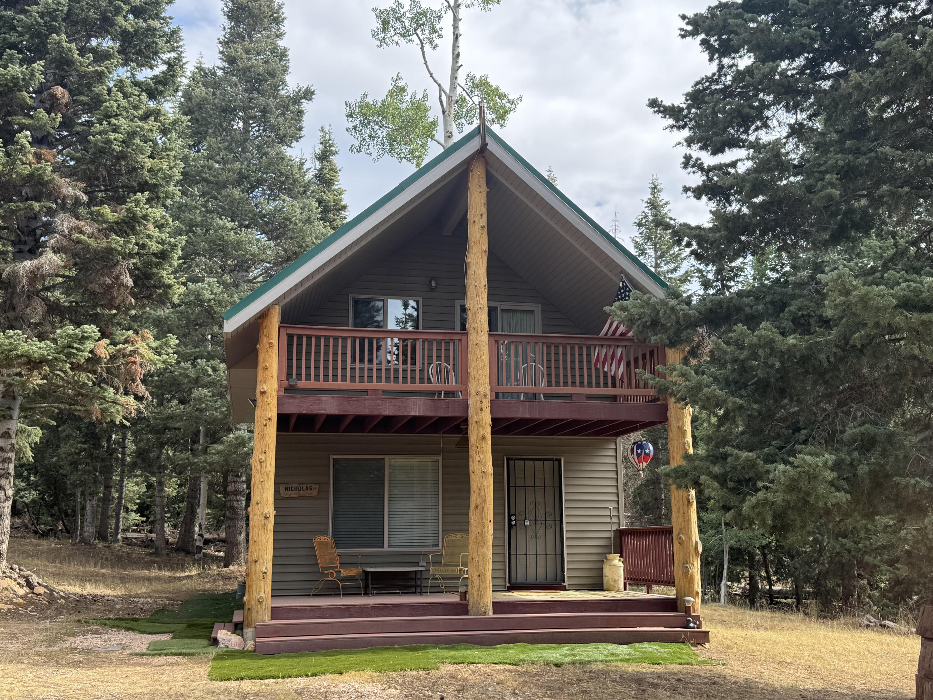 Mountain Retreat tucked in the forest with Cabin, Storage & Workshop on 1-acre lot! Escape to the serene beauty of Navajo Lake Estates with this 2-Bed, 2 Bath cabin featuring a spacious loft/bedroom for additional sleeping space. The cabin is nestled on one lot with a workshop on the other. Cabin was built in 2009-solid construction and thoughtful design. Windmill, generator and solar powered with 8 batteries, eliminating the need for electricity or the power bill. Water trailer and 1200-gallon water tank and access to a local spring, the cabin is well insulated, has pex piping, and double pained windows. Covered decks to enjoy the mtn air, RV parking. Propane fridge and stove. A travel trailer has been converted into a storage shed. Enjoy family and friends around the firepit. MUST SEE TO BELIEVE!